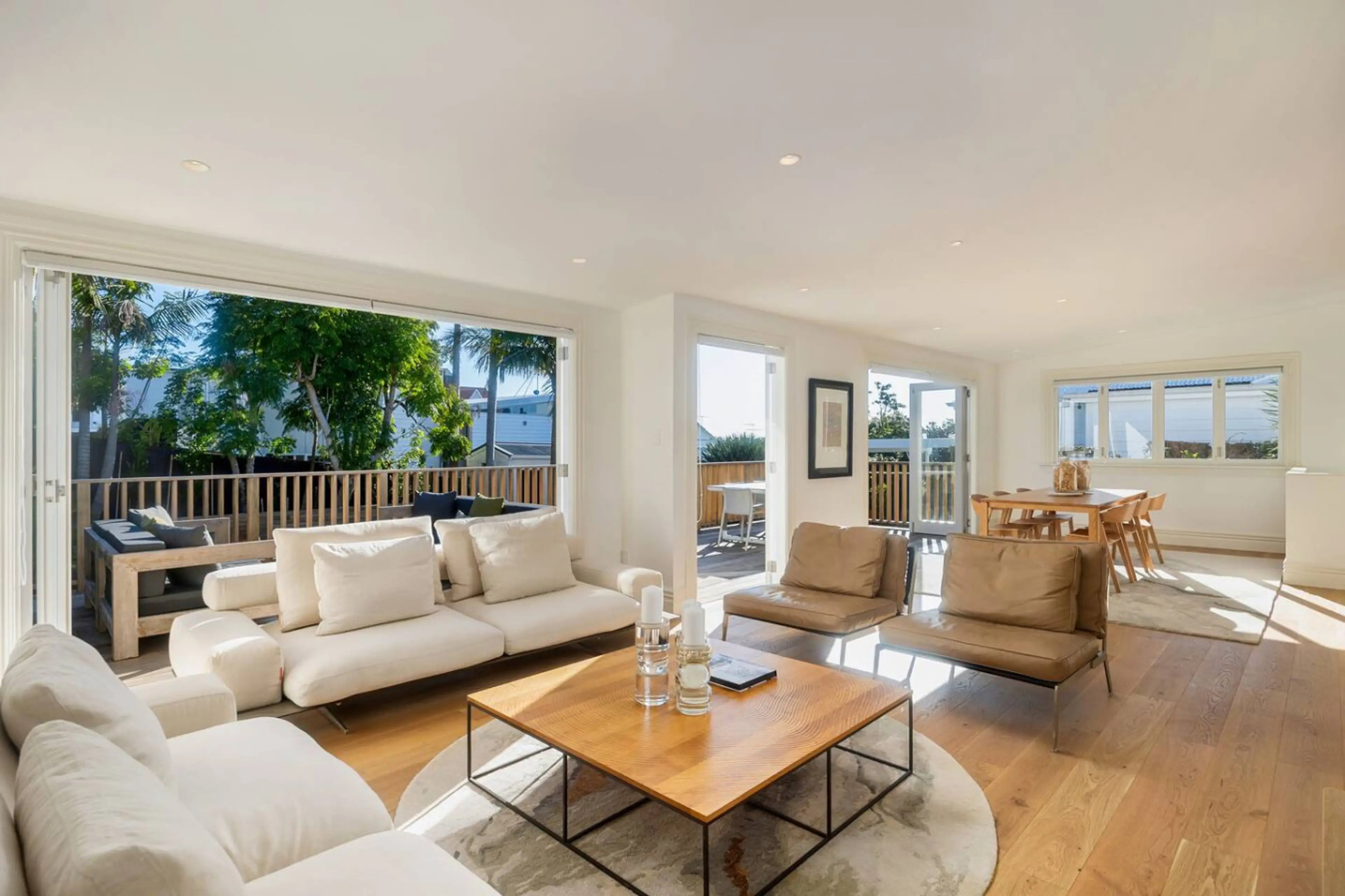 Sunny spacious open plan living and dining with bi-fold doors opening out to the sunny deck and back lawn.