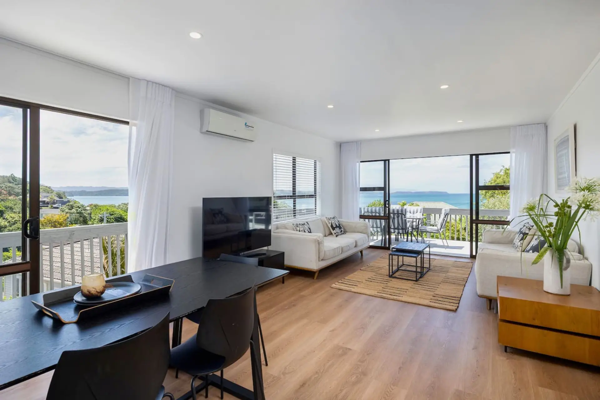 Upstairs living area with sweeping views, dining, main kitchen, complete with air conditioning and Smart TV