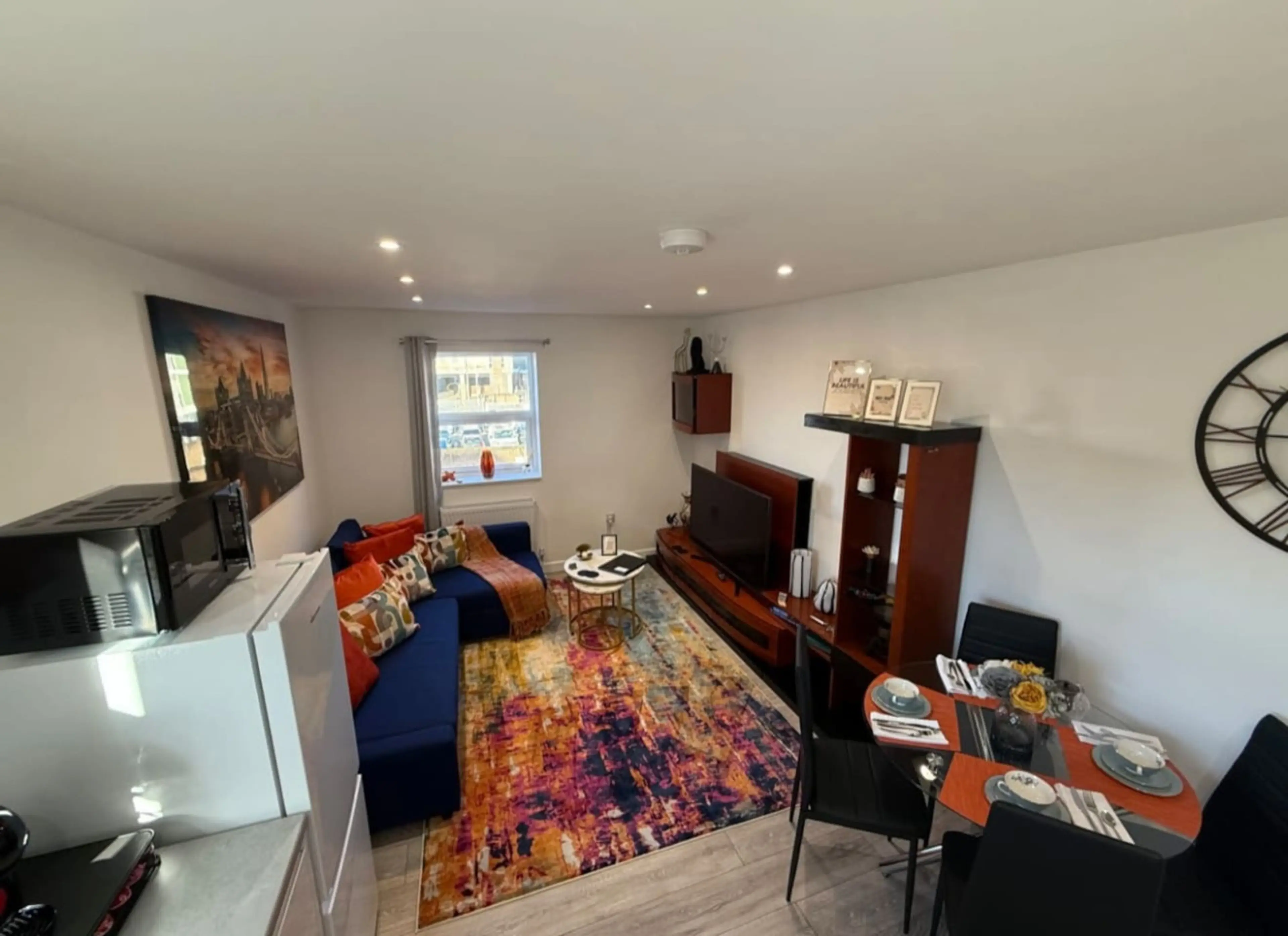 A bright and welcoming space with comfortable seating and a TV, perfect for relaxing after a day out.