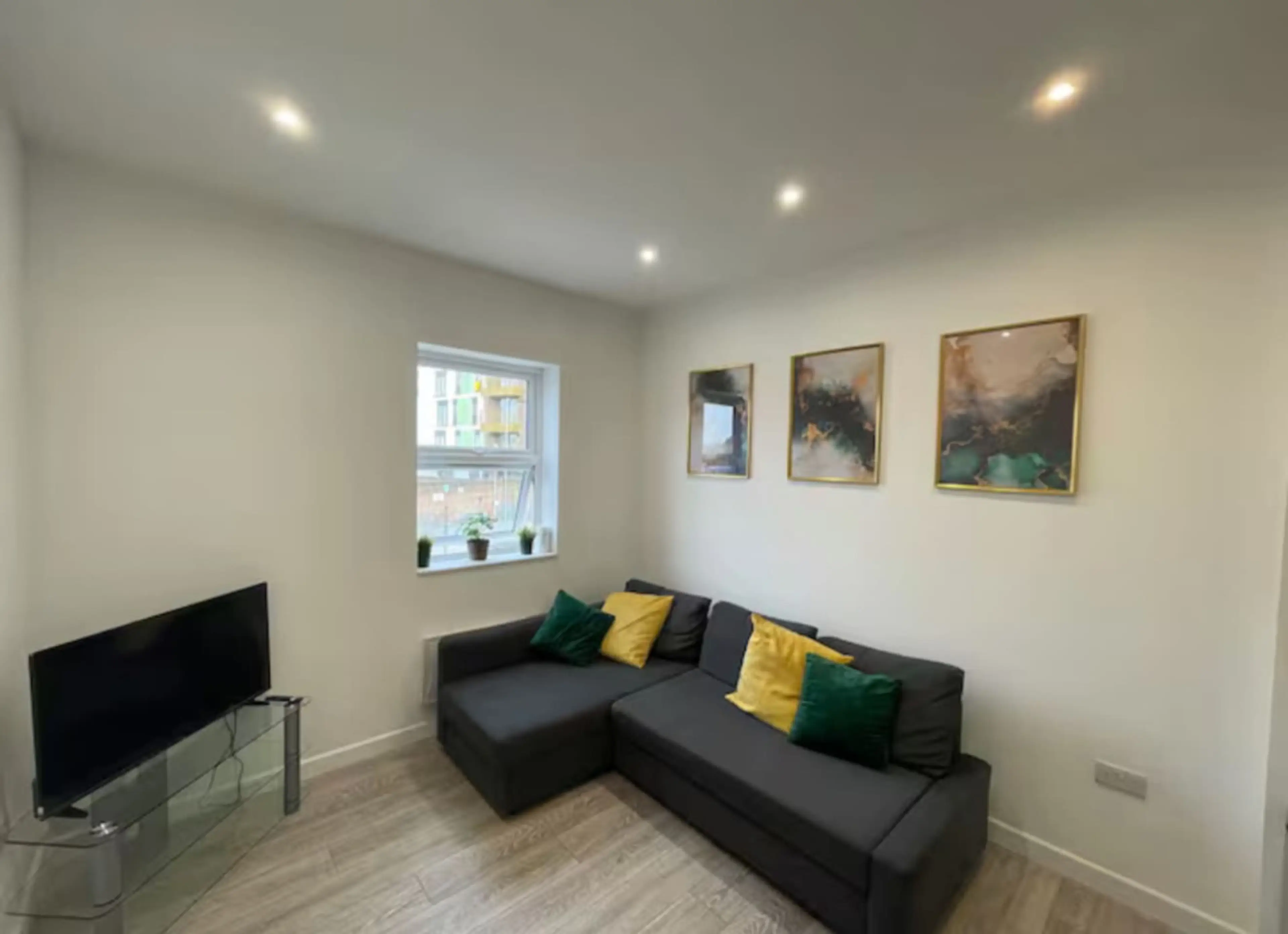 Bright and cozy lounge with comfortable seating and TV.