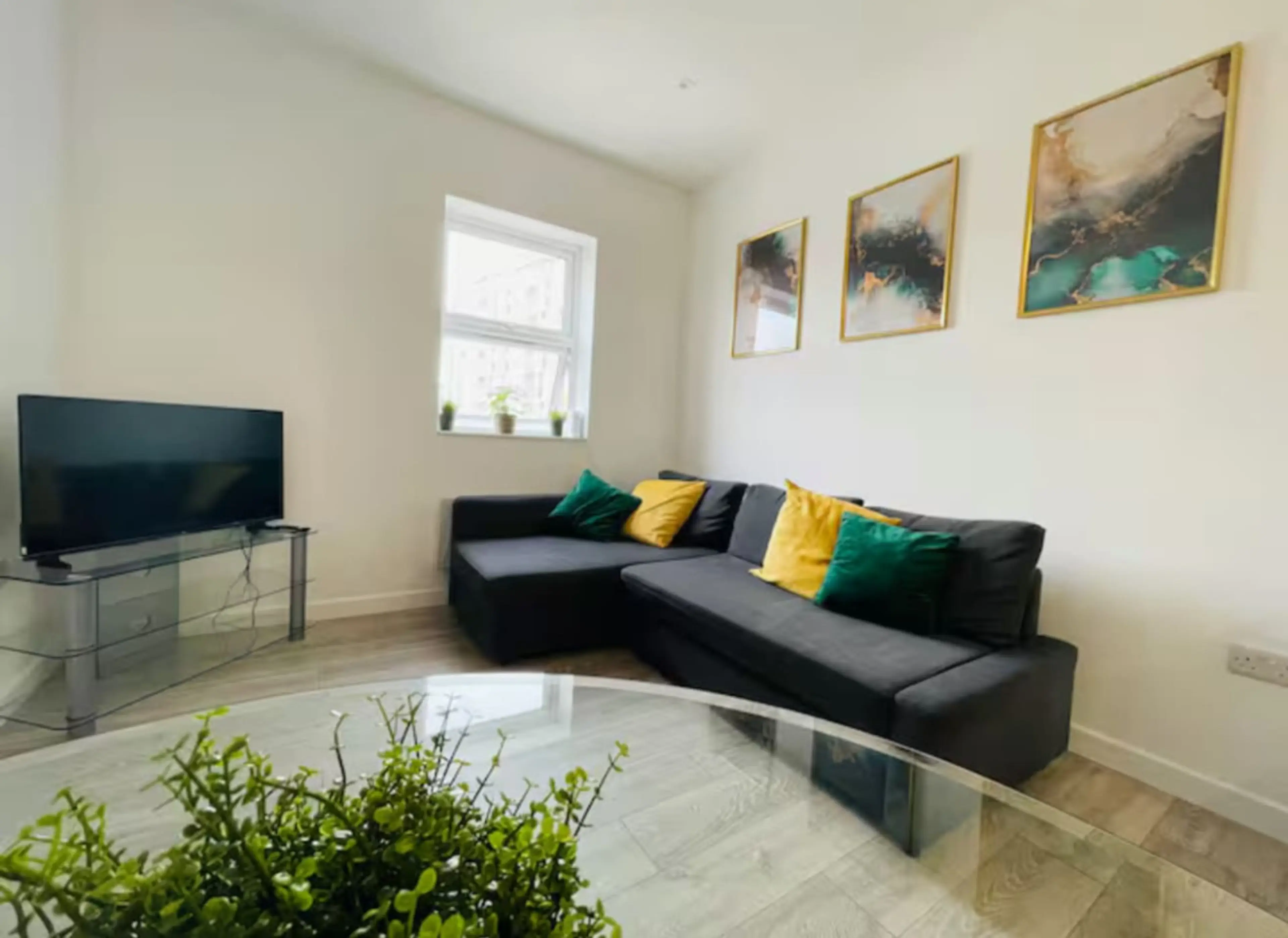 Bright and cozy lounge with comfortable seating and TV.