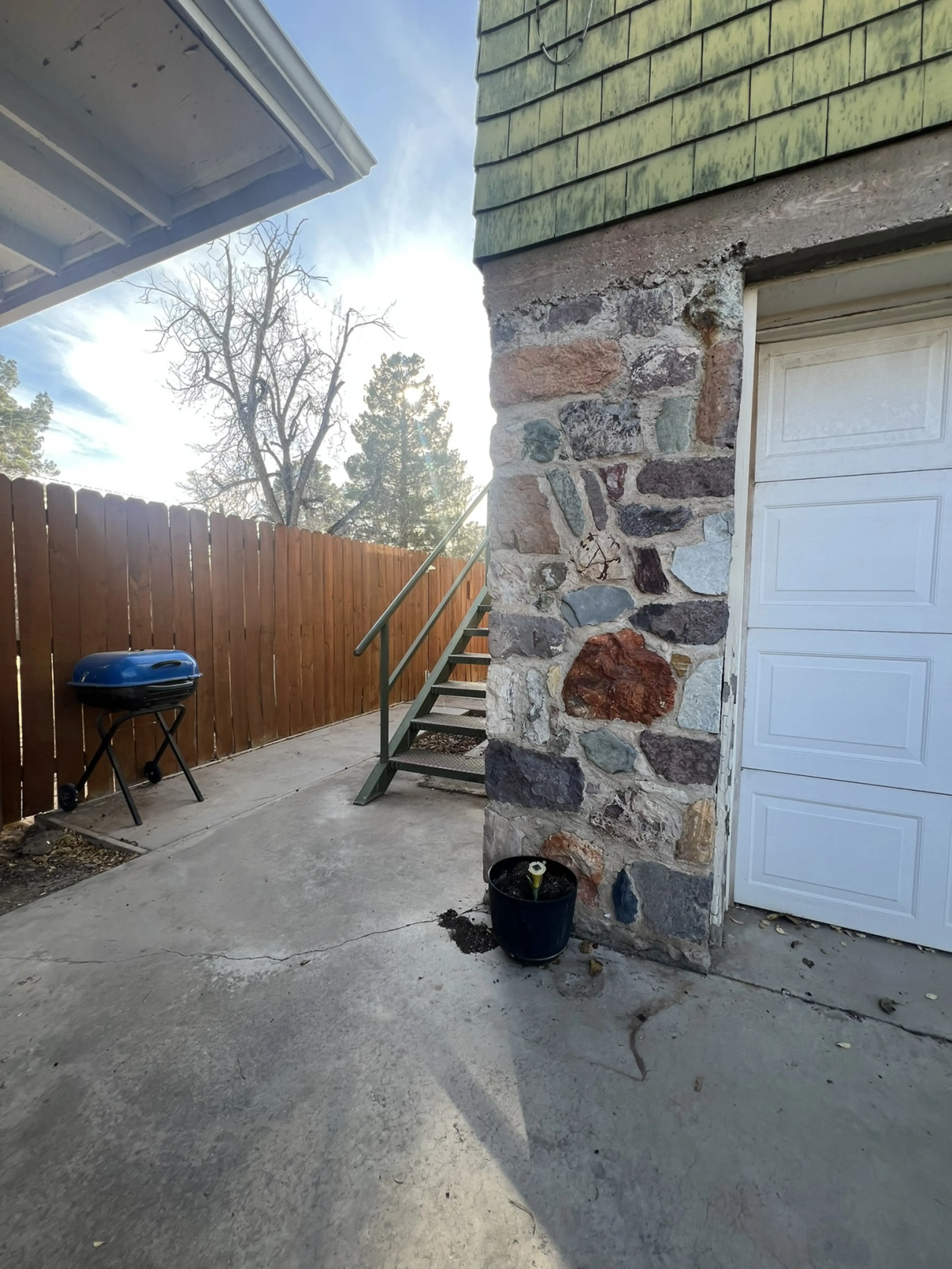Staircase to go up into the casita is past the car port and cars, to the left of the garage