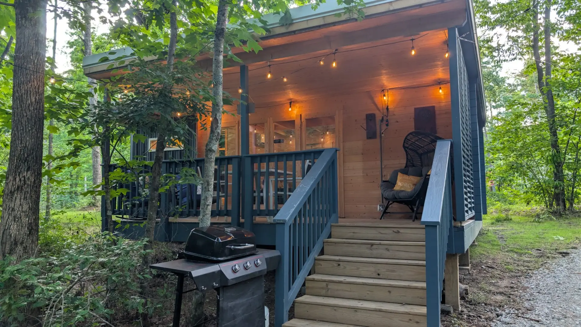 Front view of the Scandinavian Cabin at golden hour, with the porch lit.