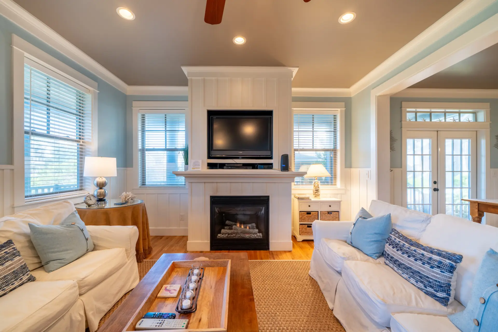 Gather around the fireplace after a day at the beach in this bright, open living space.