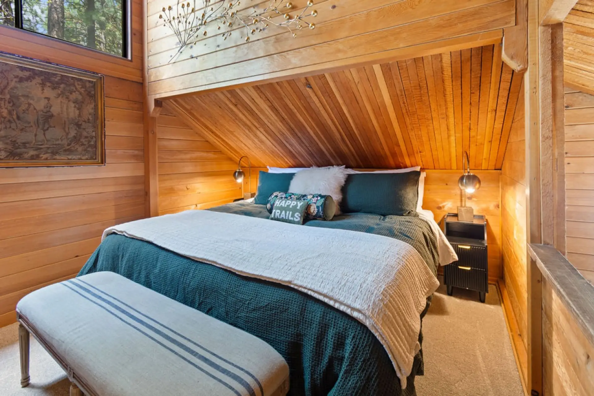 Warm wood finishes and a peaceful setting make the primary suite a comfortable retreat.