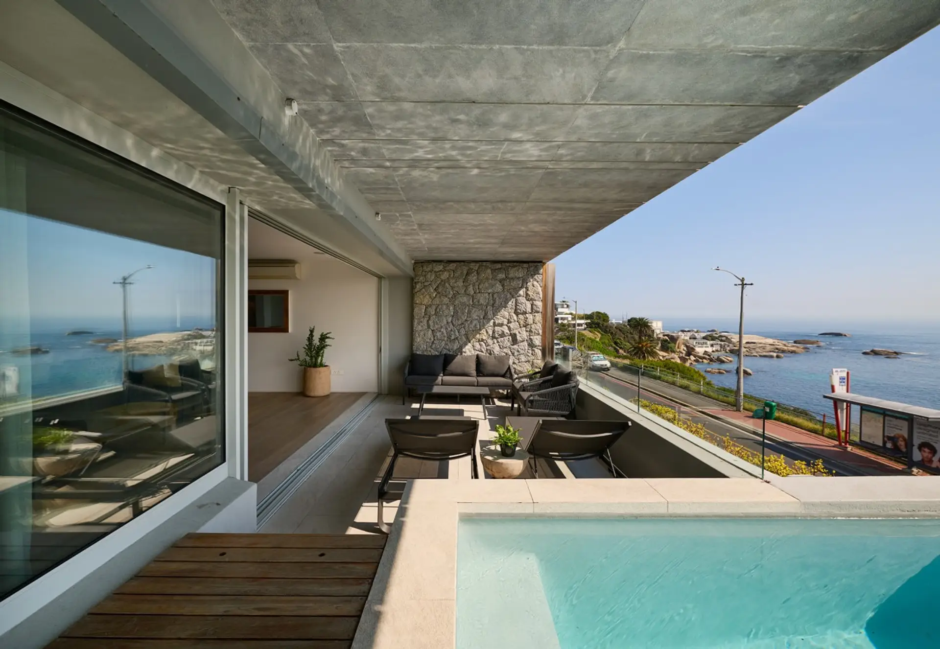 Pool terrace with sea views and outdoor seating
