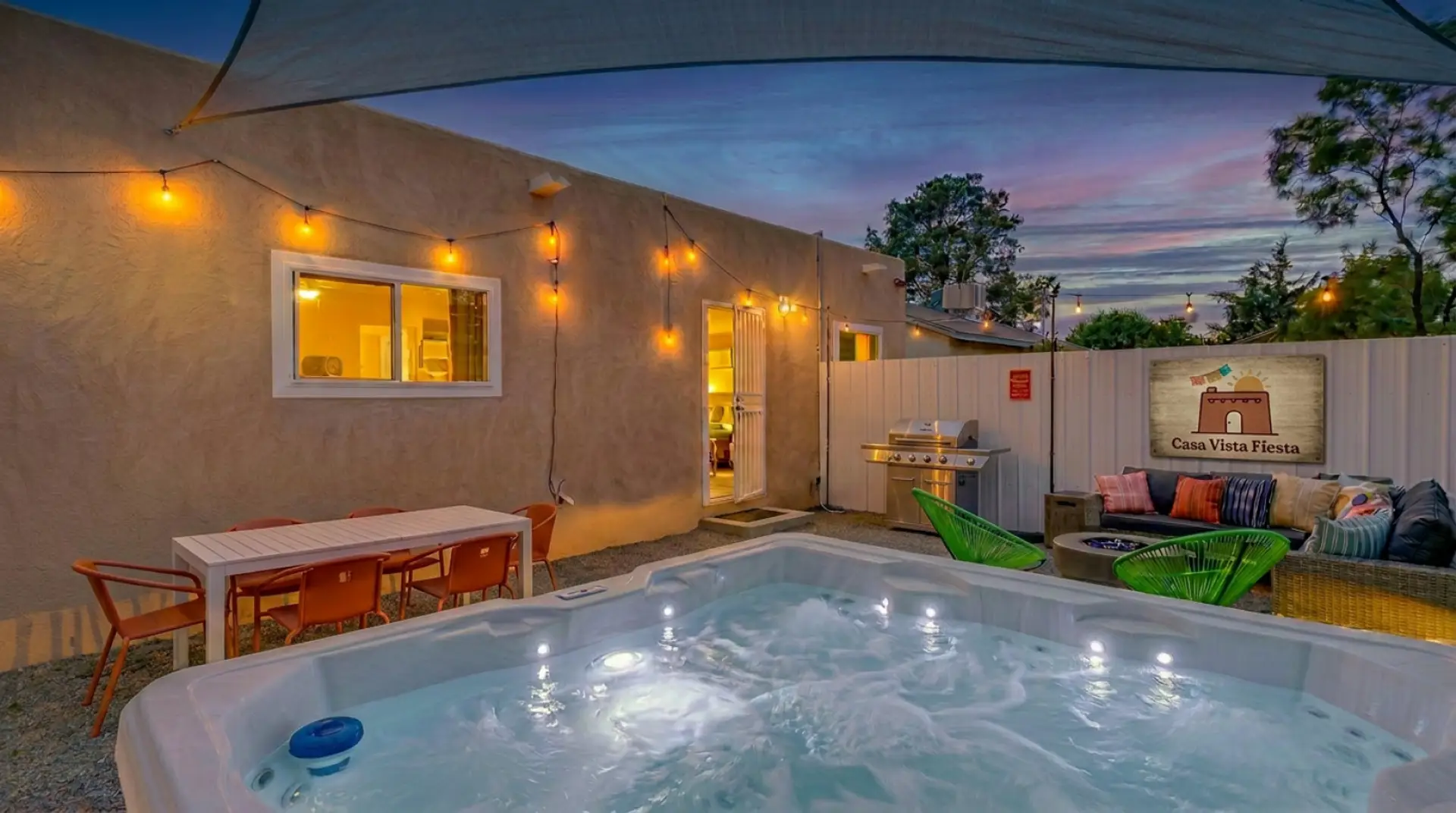 Hot tub glowing at dusk, string lights above, and the whole backyard to yourselves. This is the moment you booked it for — private hot tub, fire pit, and a New Mexico sky that doesn't disappoint. Albuquerque vacation rental with private hot tub.