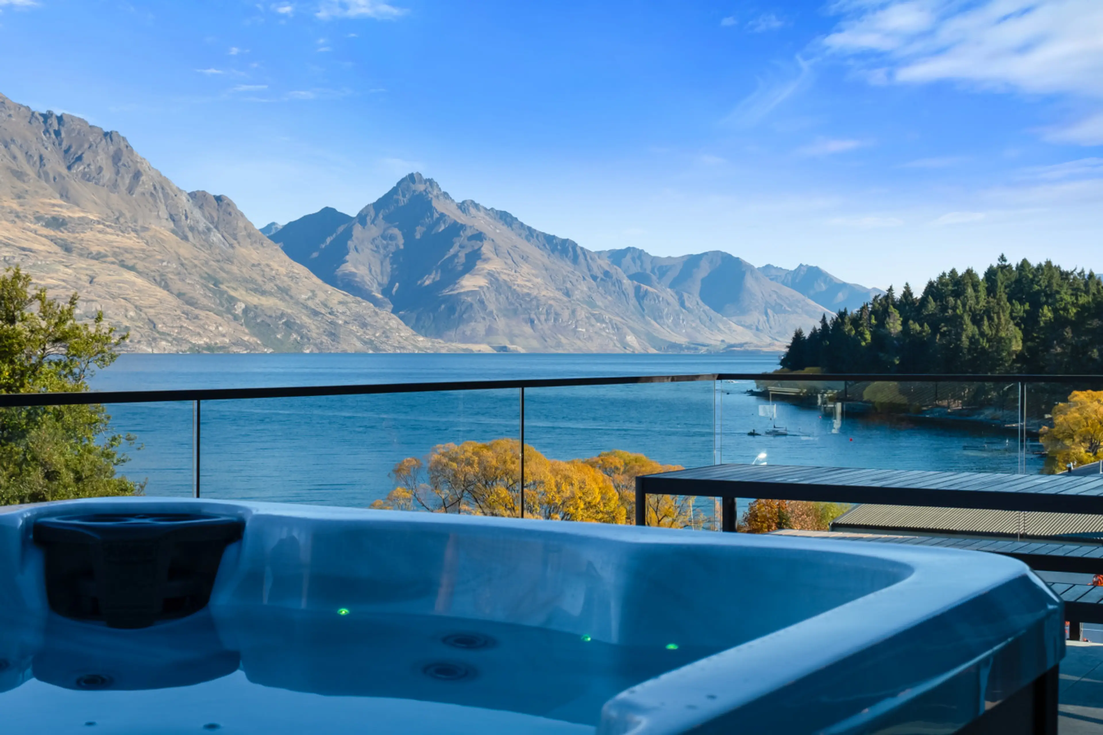 Hot tub with Lake Wakatipu and Botanic Gardens in the background