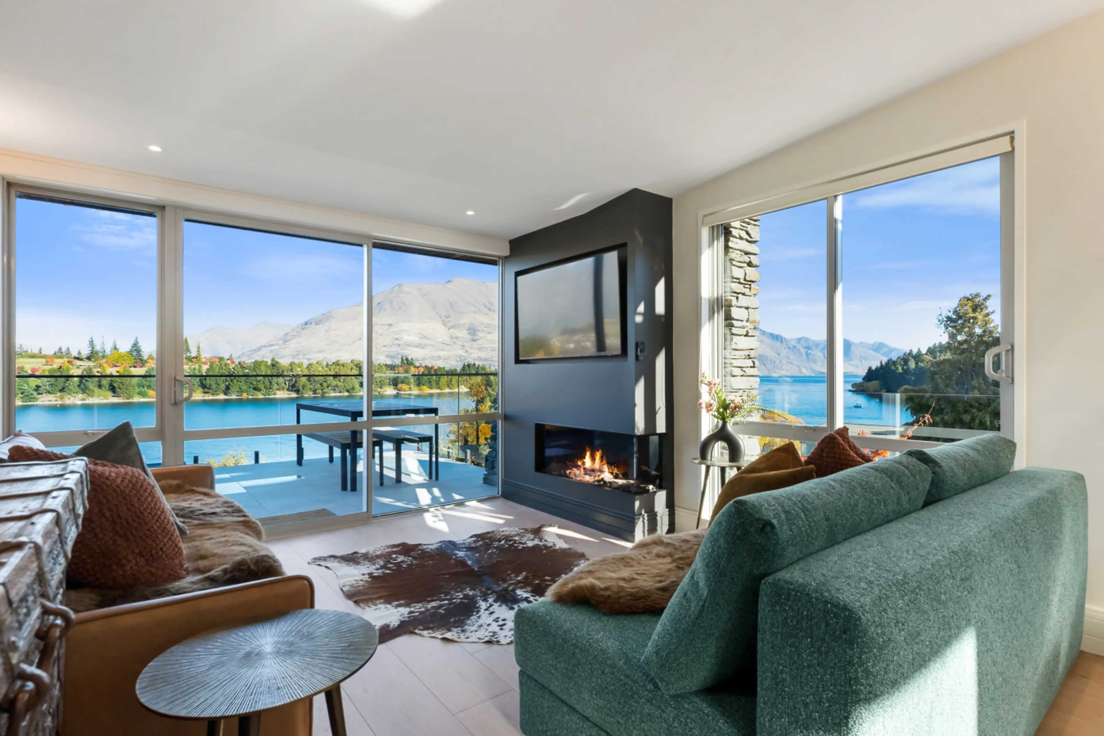 The living room from the deck - fireplace at centre, lake on two sides