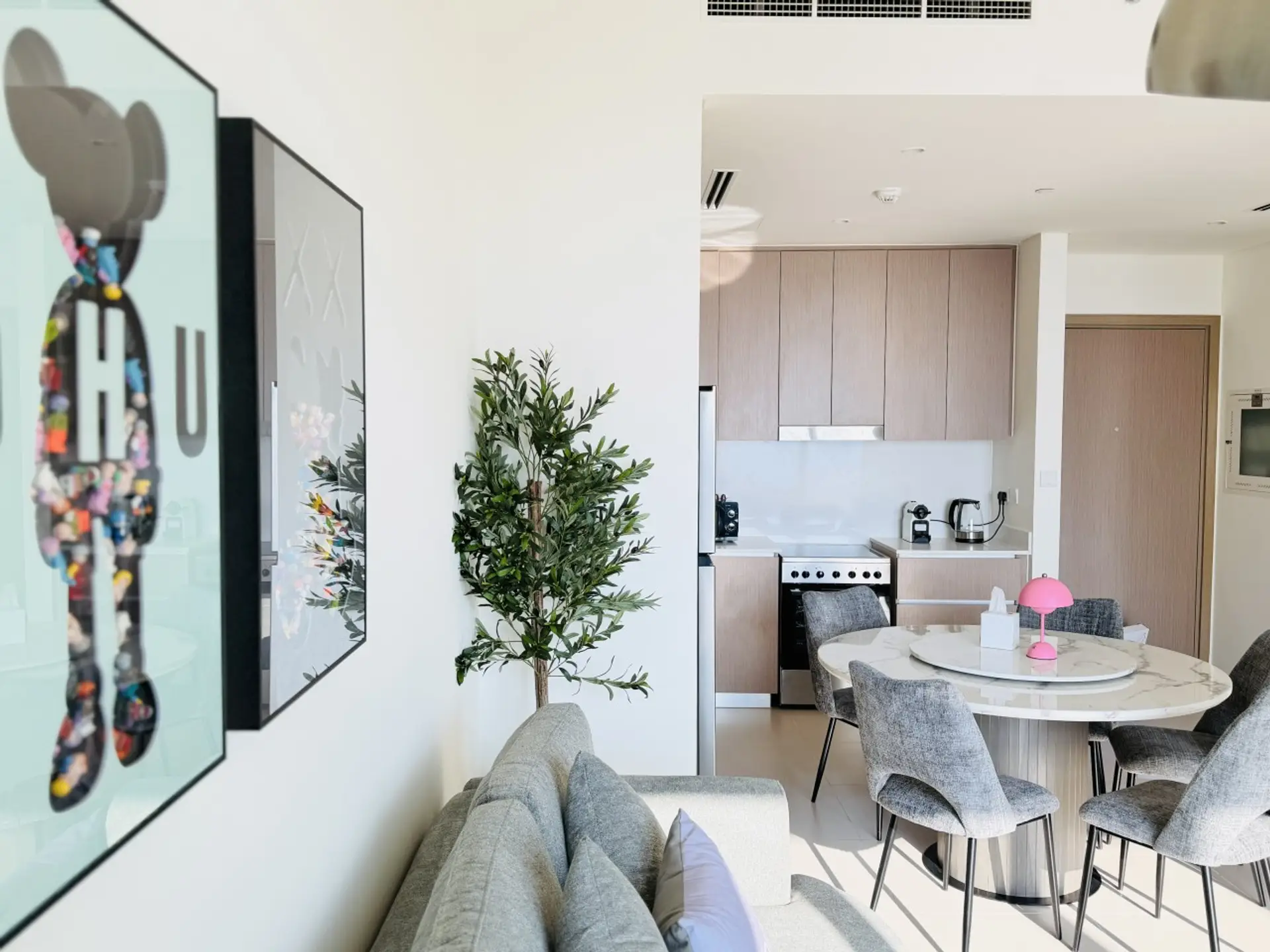 Open living and dining area alongside the sleek kitchen.