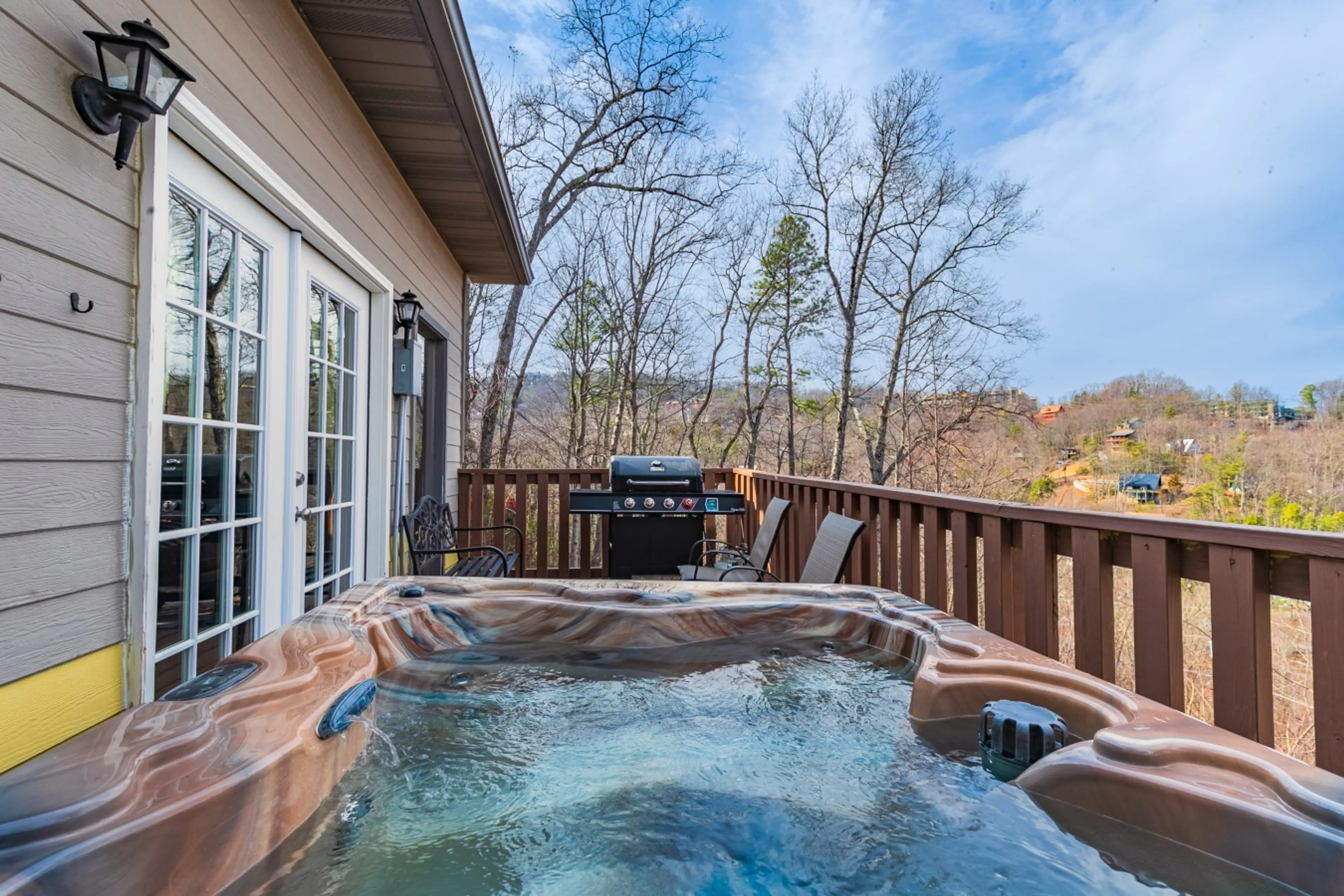 Private hot tub on the deck — Smoky Mountain views through the pines