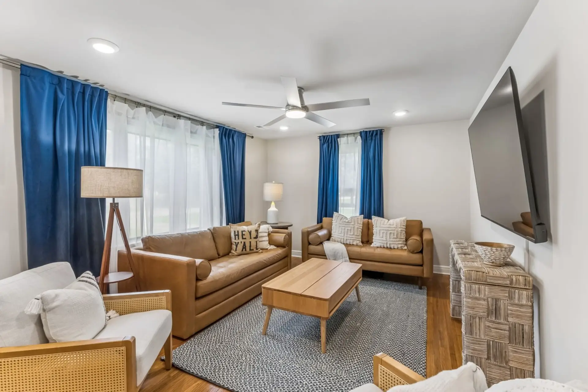 Spacious living room with queen sofa bed, Smart TV, ceiling fan, and plenty of space for your group.