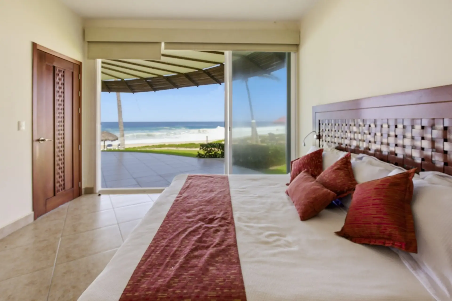 Master bedroom with direct oceanfront views and resort amenities