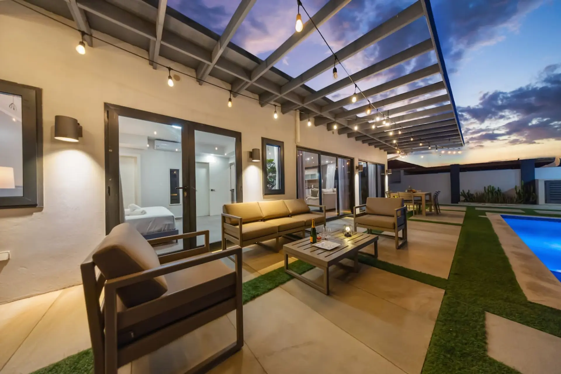 Covered terrace with cozy outdoor lounge seating.