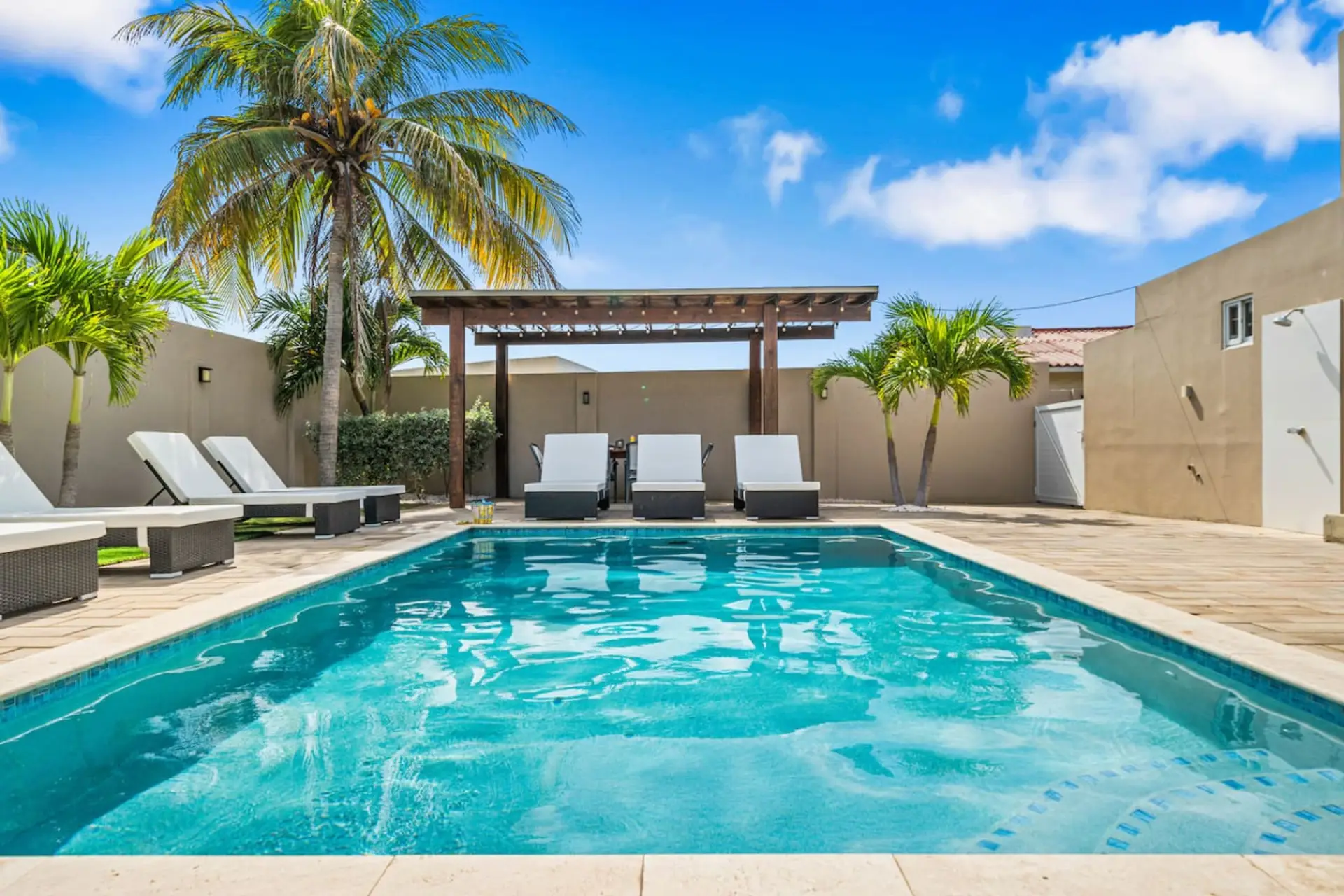 Enjoy the sunshine by your exclusive poolside deck in Aruba