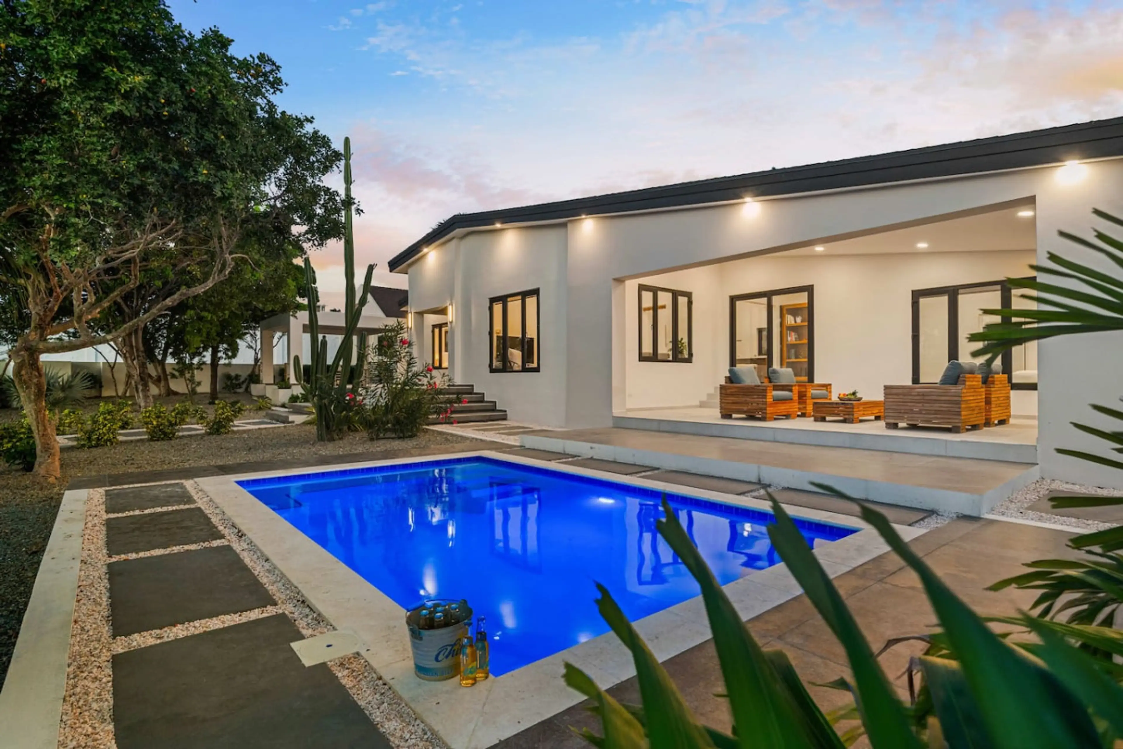 Private pool with tropical landscaping and outdoor seating