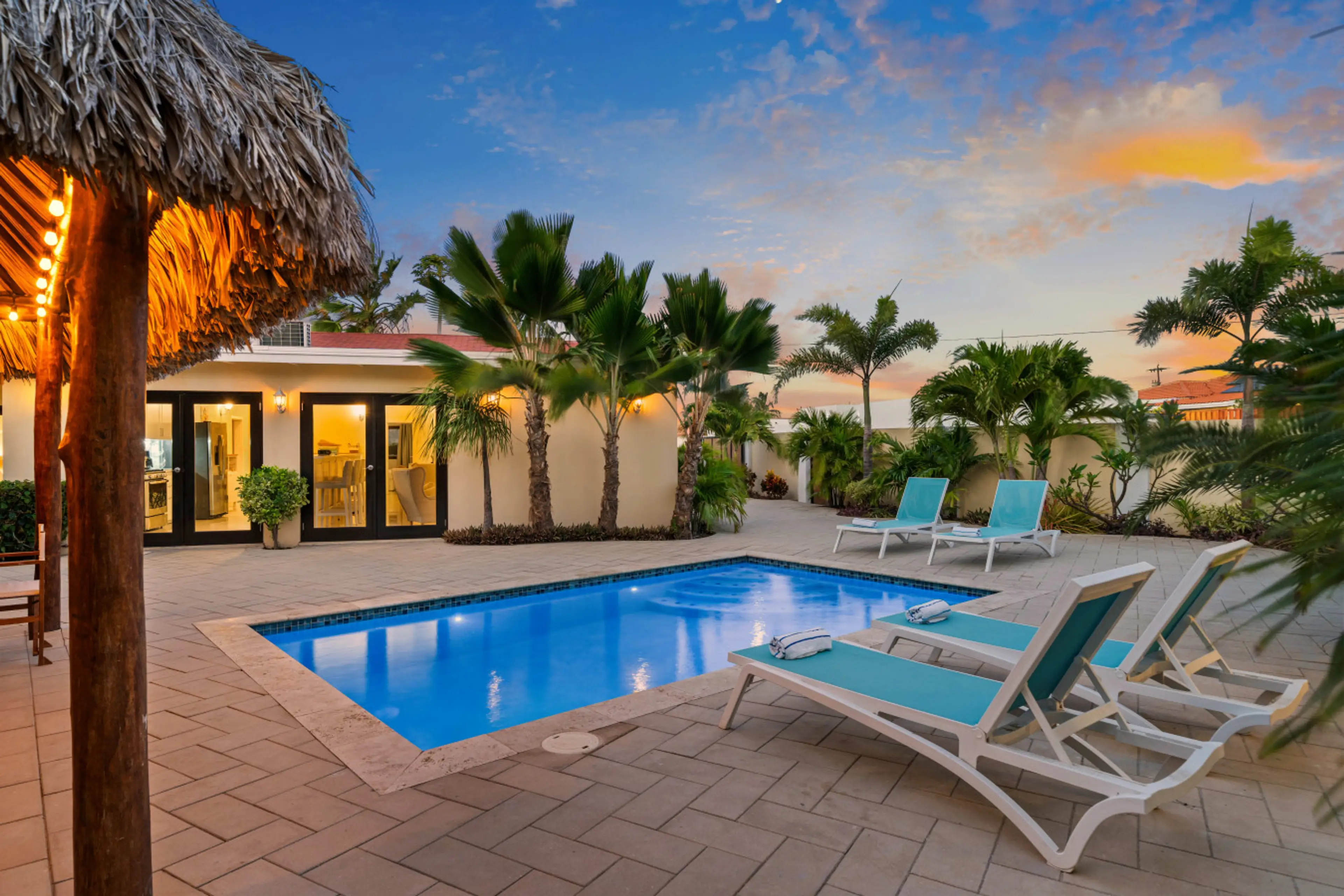 Private pool at sunset with loungers perfect for relaxing Aruba evenings