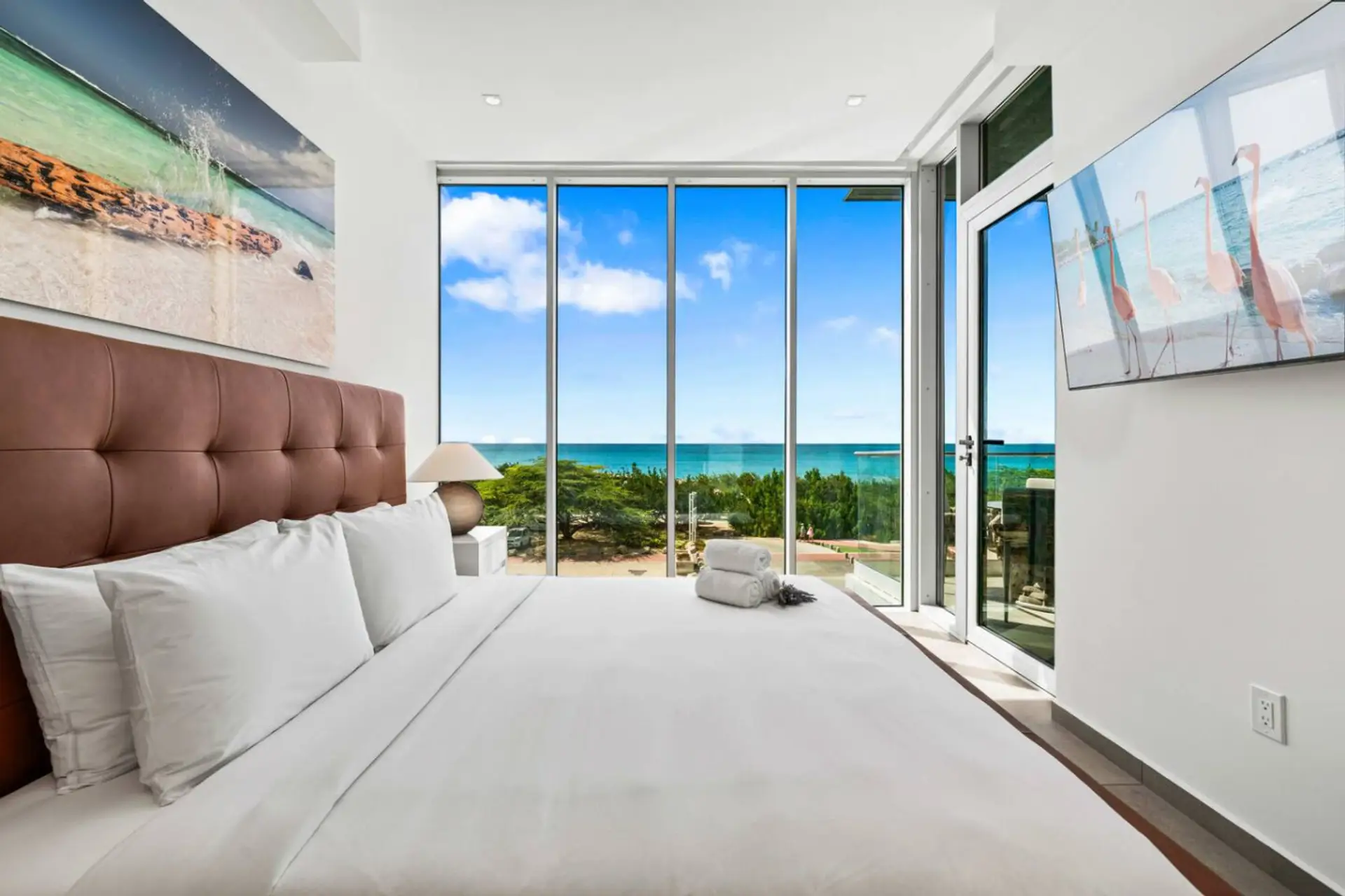 Aruba ocean view bedroom with balcony and floor to ceiling windows
