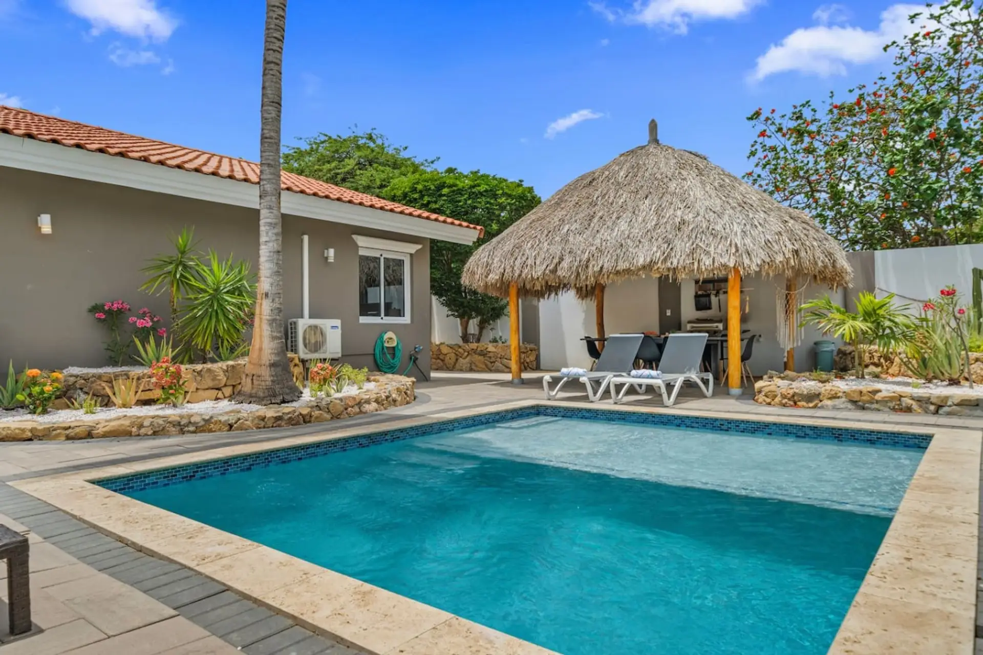 Private outdoor retreat with a sparkling pool, tropical landscaping, and a shaded gazebo for relaxing afternoons.