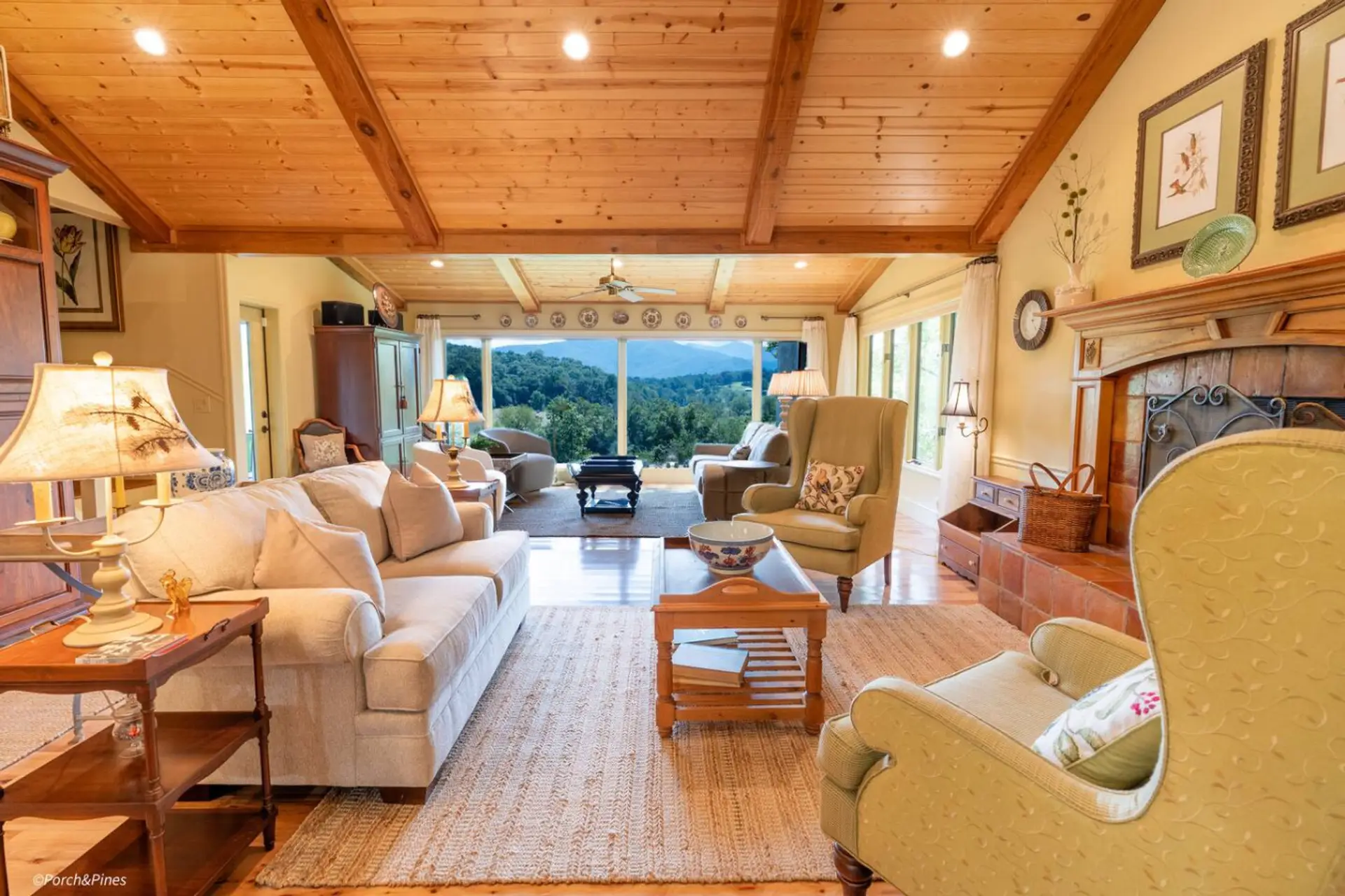 Inviting living room with large windows overlooking scenic mountain landscapes.