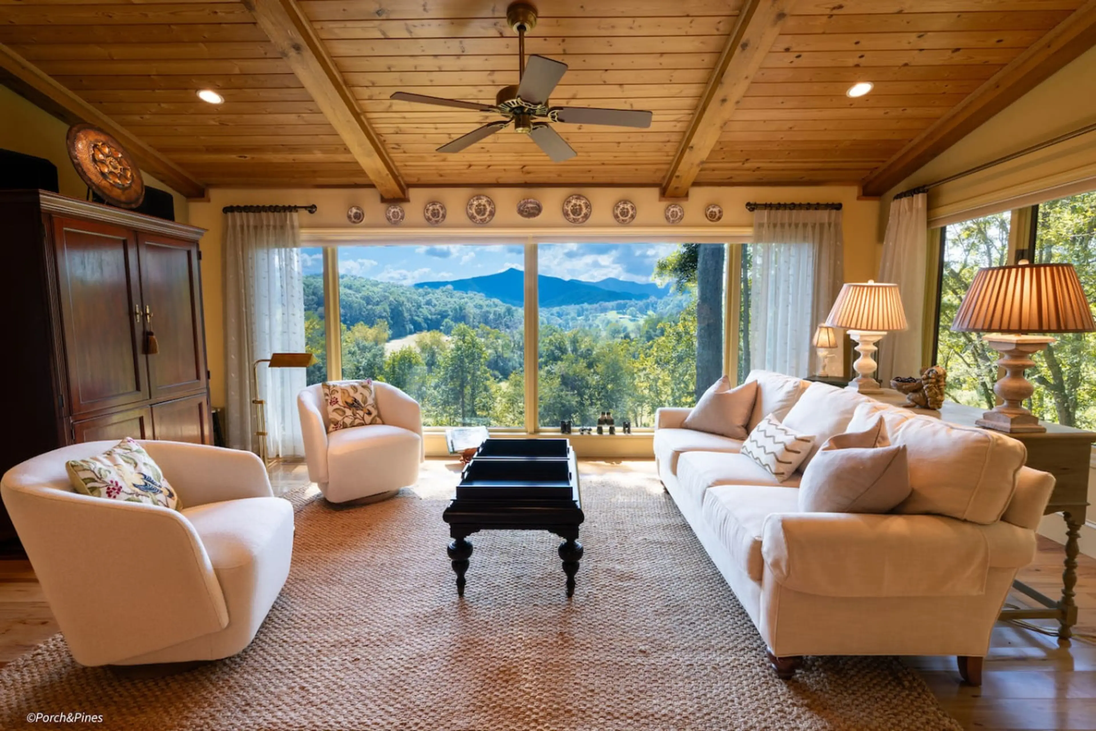 Elegant mountain-view living room with vaulted ceilings, cozy seating, and breathtaking scenery.