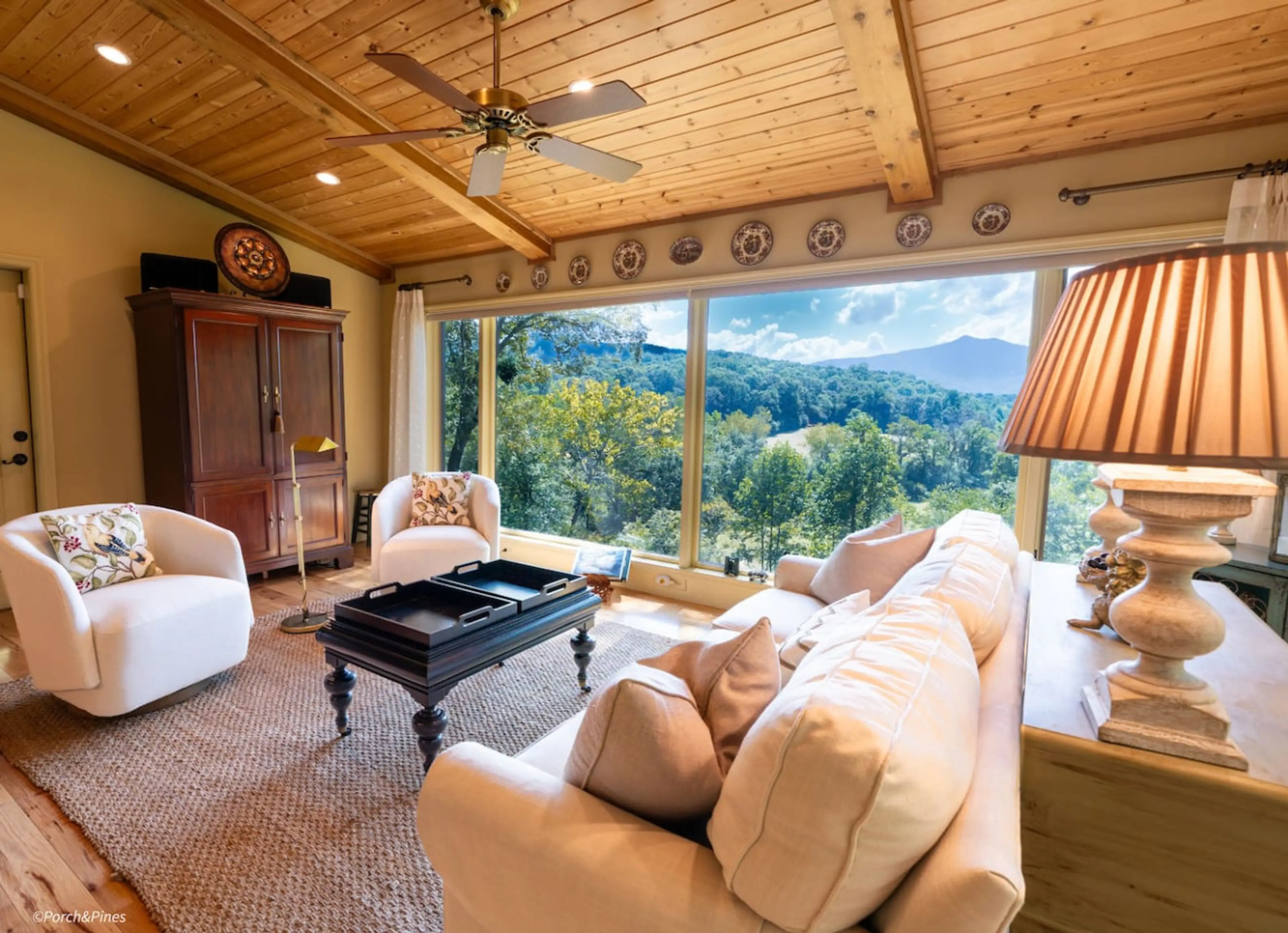 Comfortable living room with mountain views, natural light, and rustic elegance.