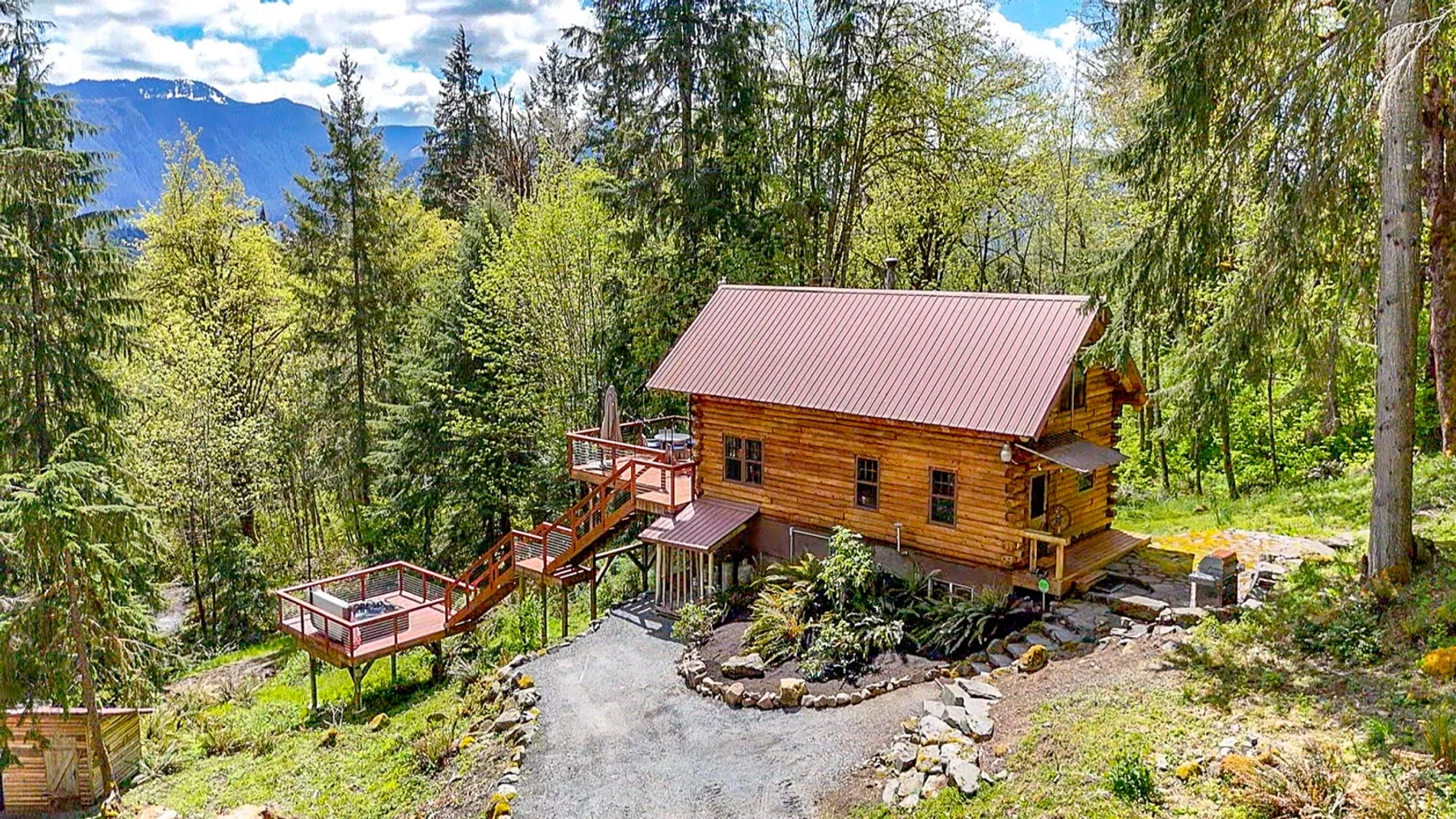 MossHenge cabin surrounded by evergreen forest near Mount Rainier