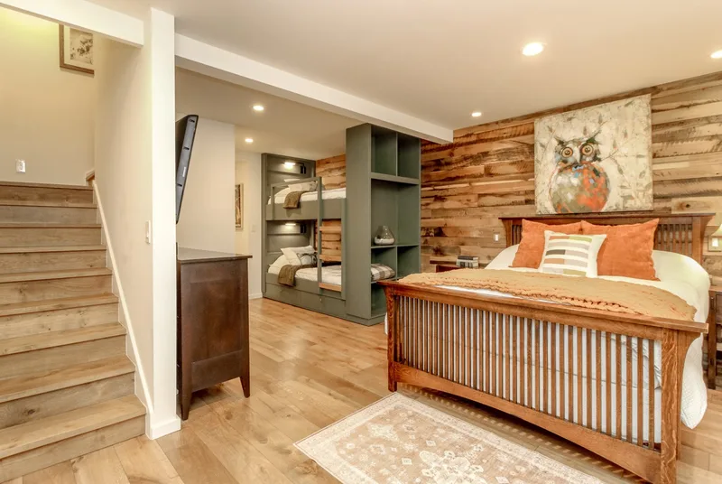 Lower-level bedroom with queen bed and built-in bunks