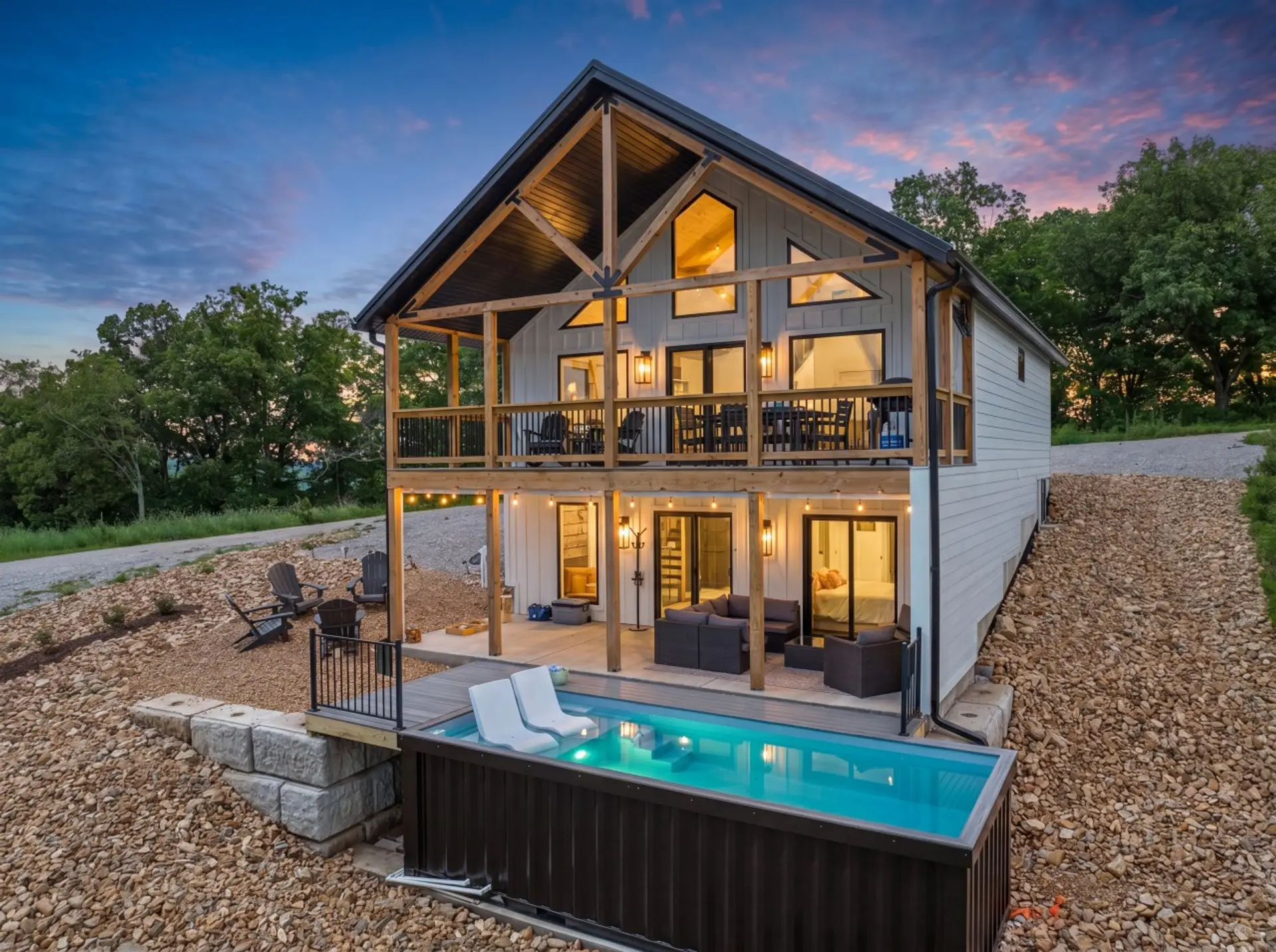 Evenings are magical as the cabin glows against colorful Ozark sunsets.