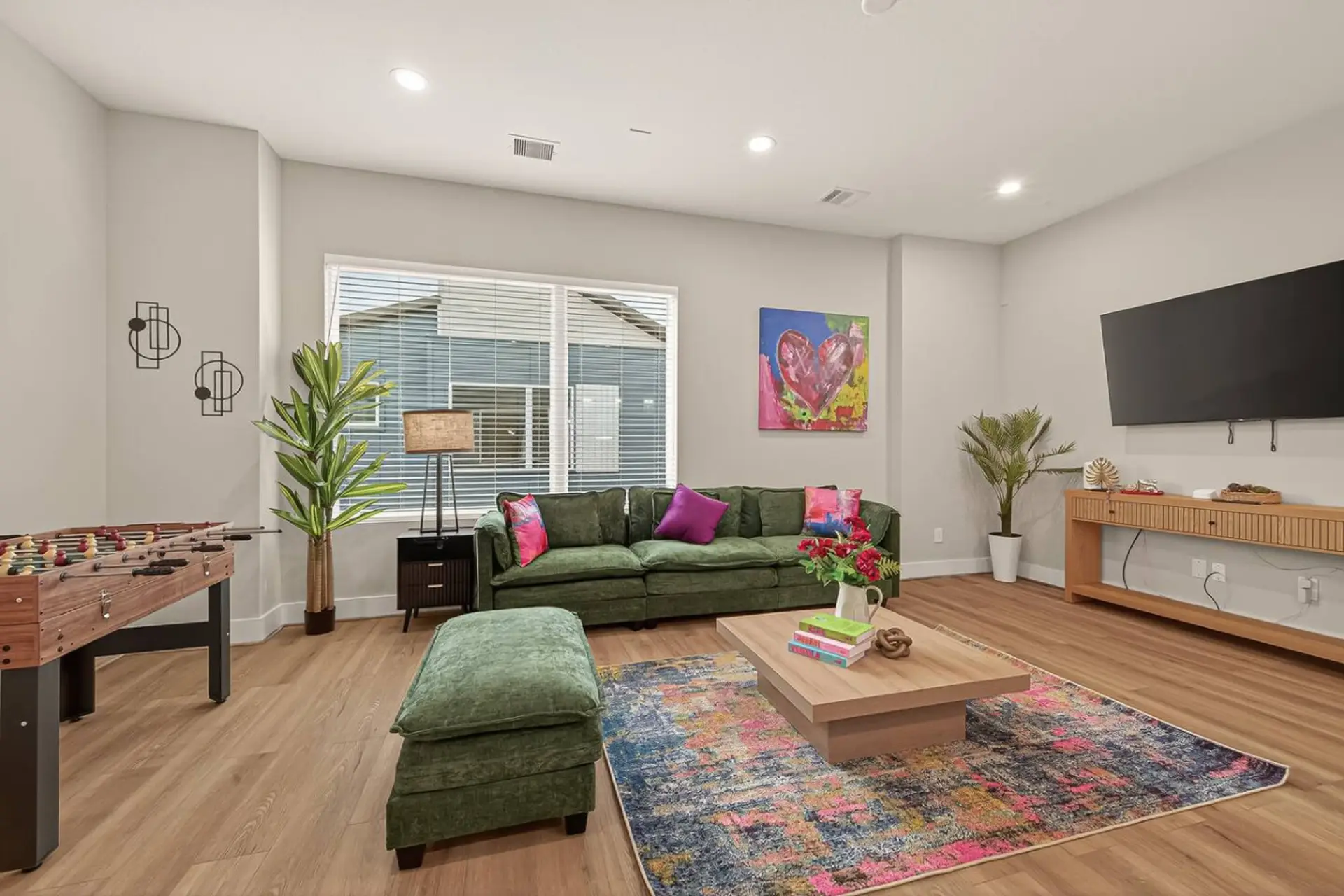 Living Room: Fun, stylish space with foosball, vibrant art, and bright windows to enjoy