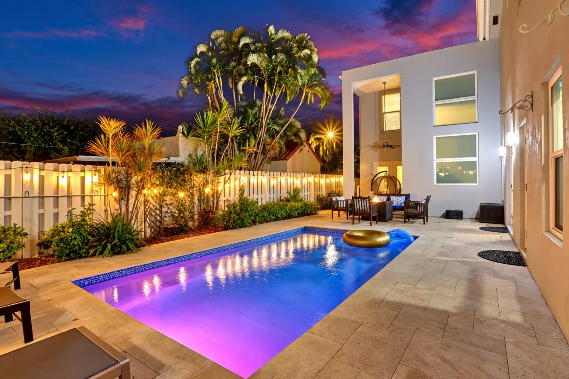 Unwind by the pool and enjoy the warm glow of this private tropical retreat after sunset. ✨🌴💦