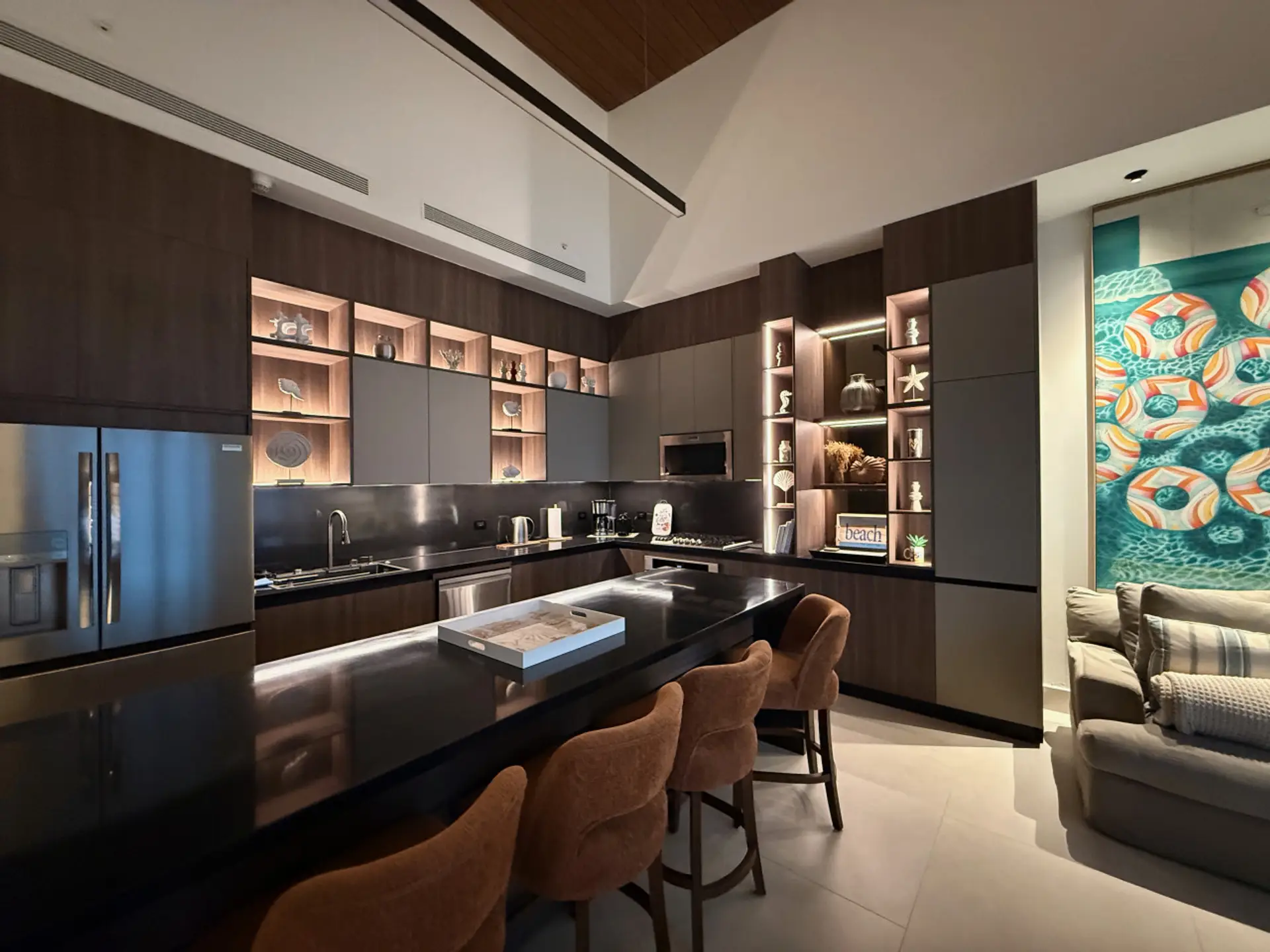 Sleek open-concept kitchen featuring an oversized island with seating for 8, premium appliances, and custom lighting—perfect for entertaining and gathering.