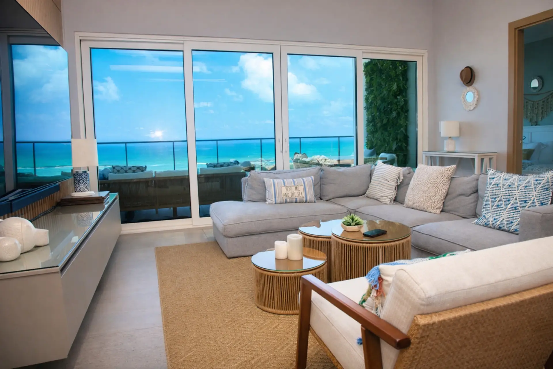 Open-concept living room with natural light, comfortable seating, and direct ocean views.