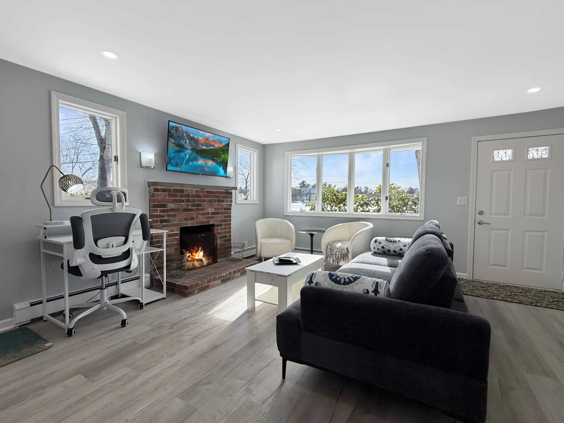 Bright and airy living room with comfy seating, a cozy fireplace, and a TV for relaxing evenings!