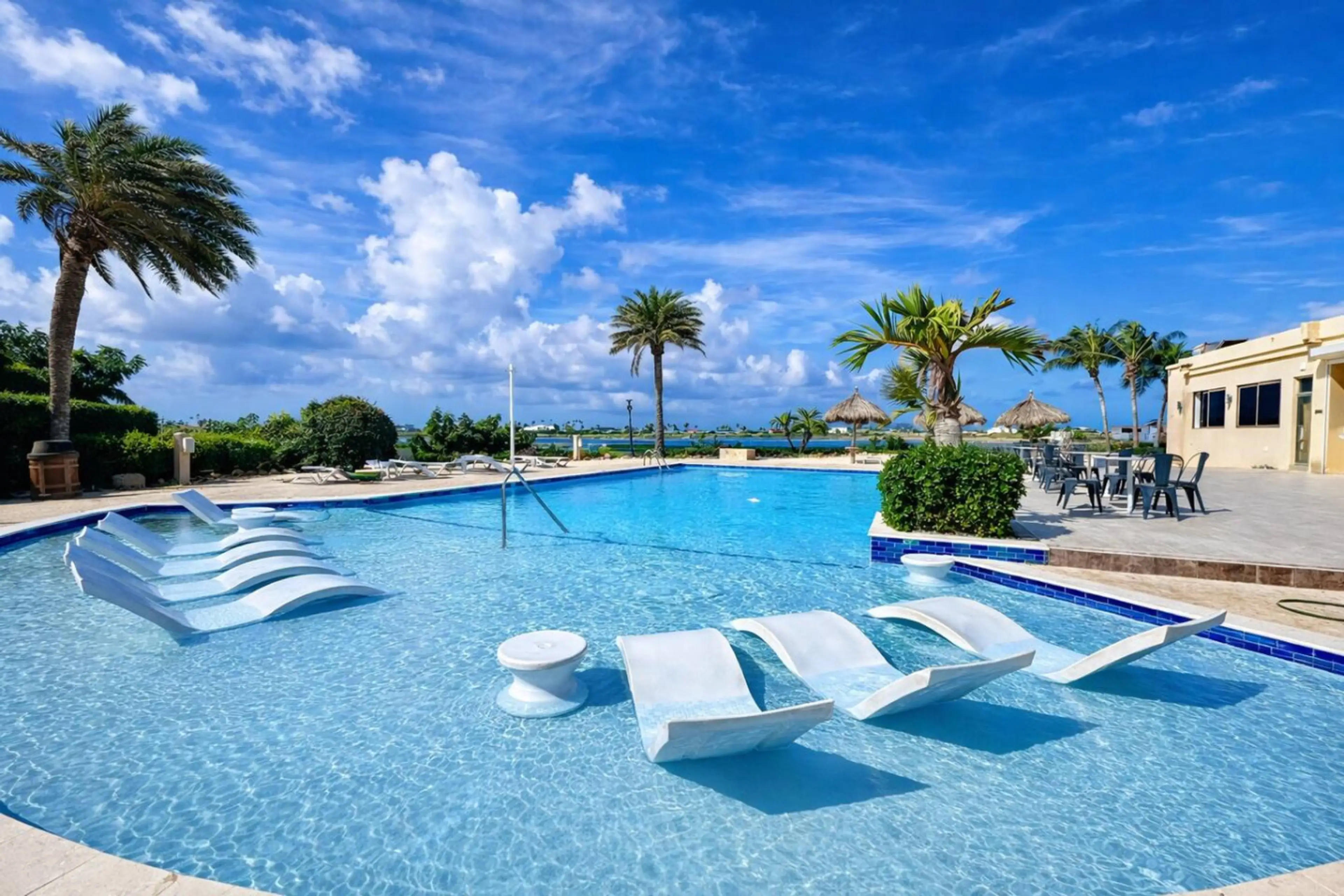 Resort pool with lounge chairs at Gold Coast Aruba