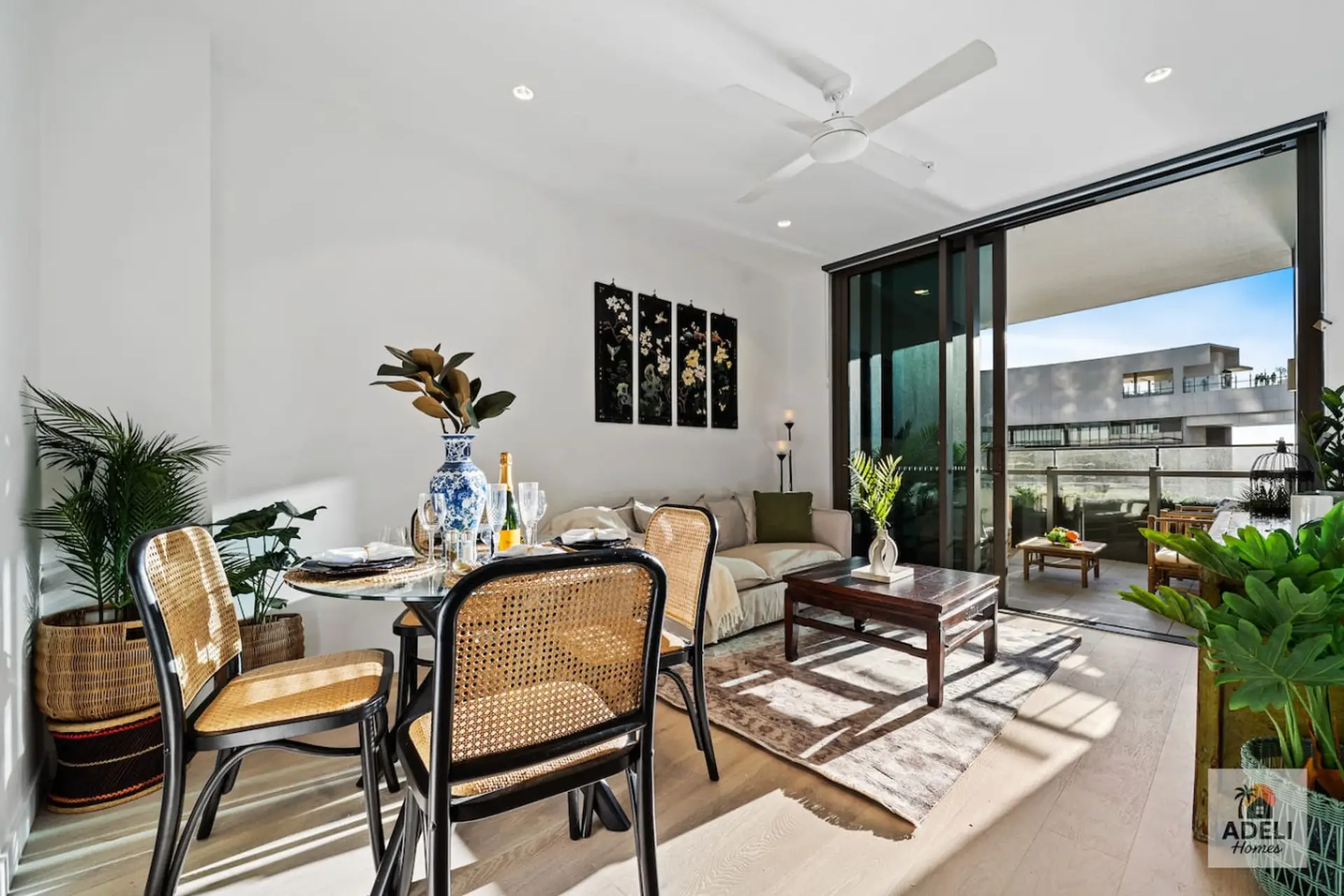 Thoughtfully styled with natural textures and greenery, this open-plan area flows seamlessly to the balcony.