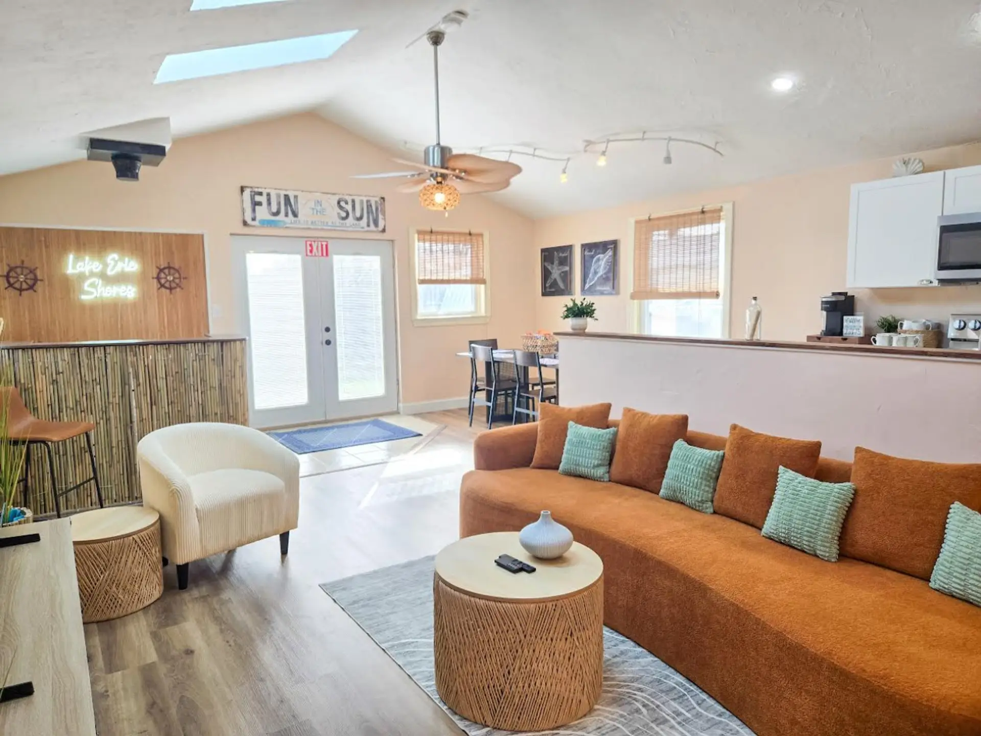Gather in the spacious open-concept lounge, complete with comfortable seating, a tiki bar, dining area, and kitchen.