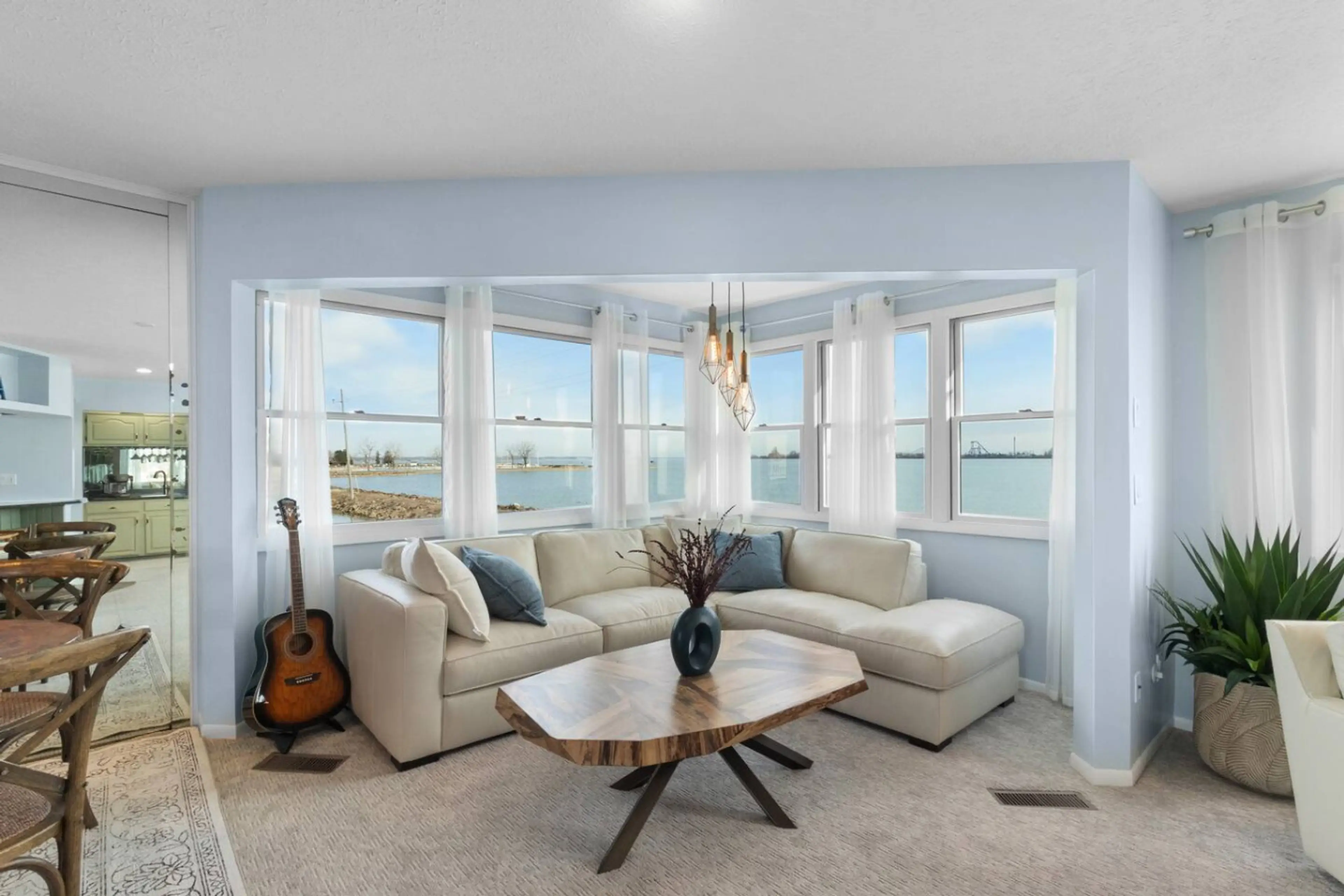 Relax in the sunlit lounge with panoramic water views and Cedar Point visible in the background