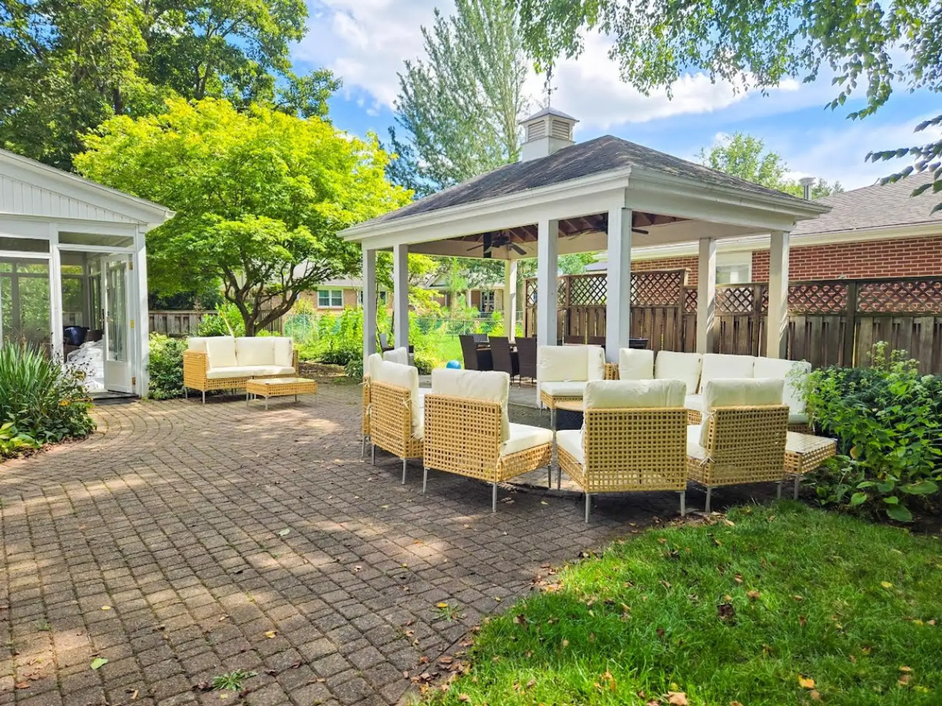 A spacious backyard retreat with abundant seating, a covered dining gazebo, and plenty of room for everyone to relax together.