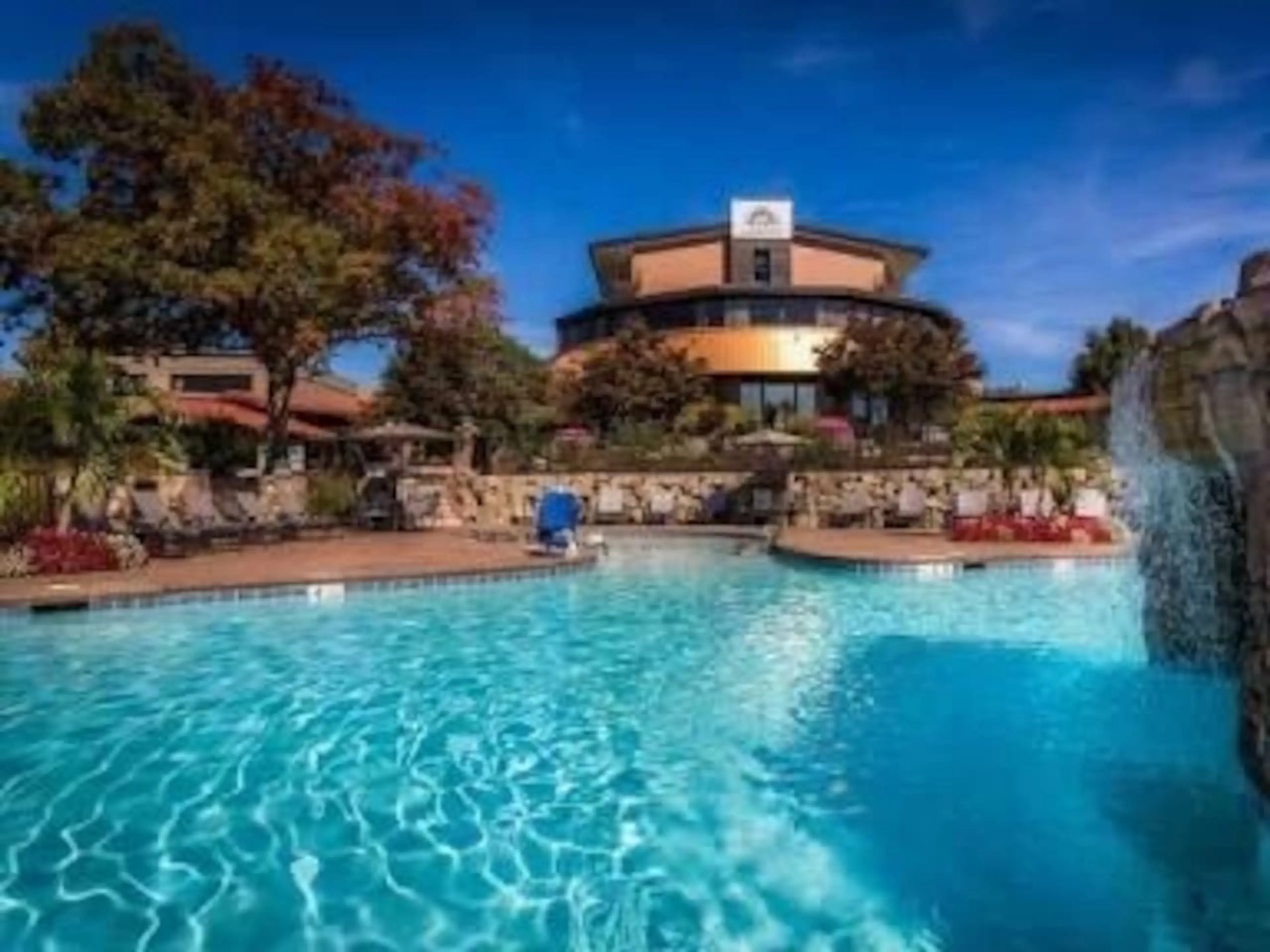 Unwind by the stunning outdoor pool with a cascading waterfall backdrop—resort luxury at its finest.