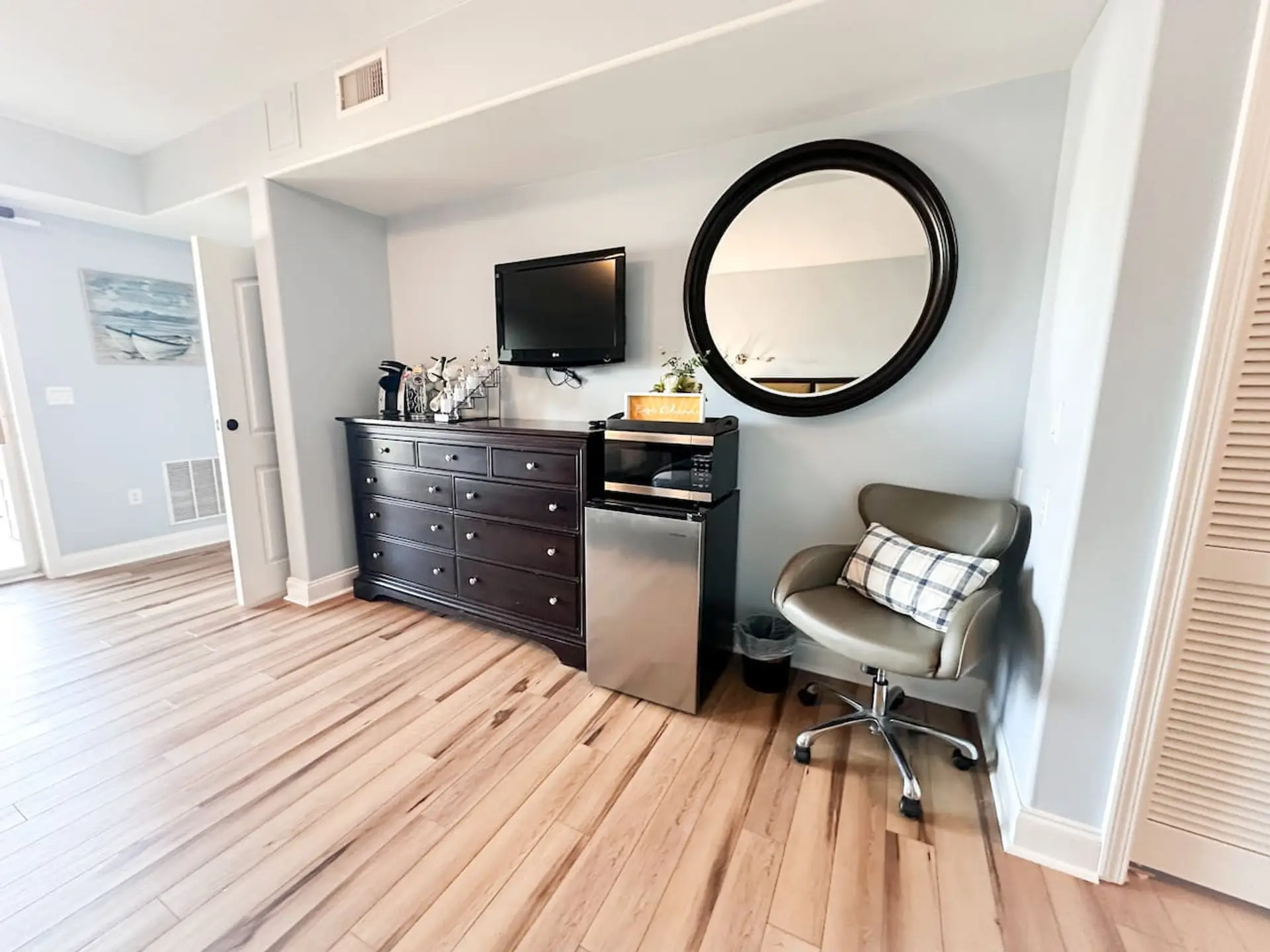 Kick back in the stylish lounge area, complete with a flat-screen TV, cozy chair, and a spacious dresser for all your essentials.