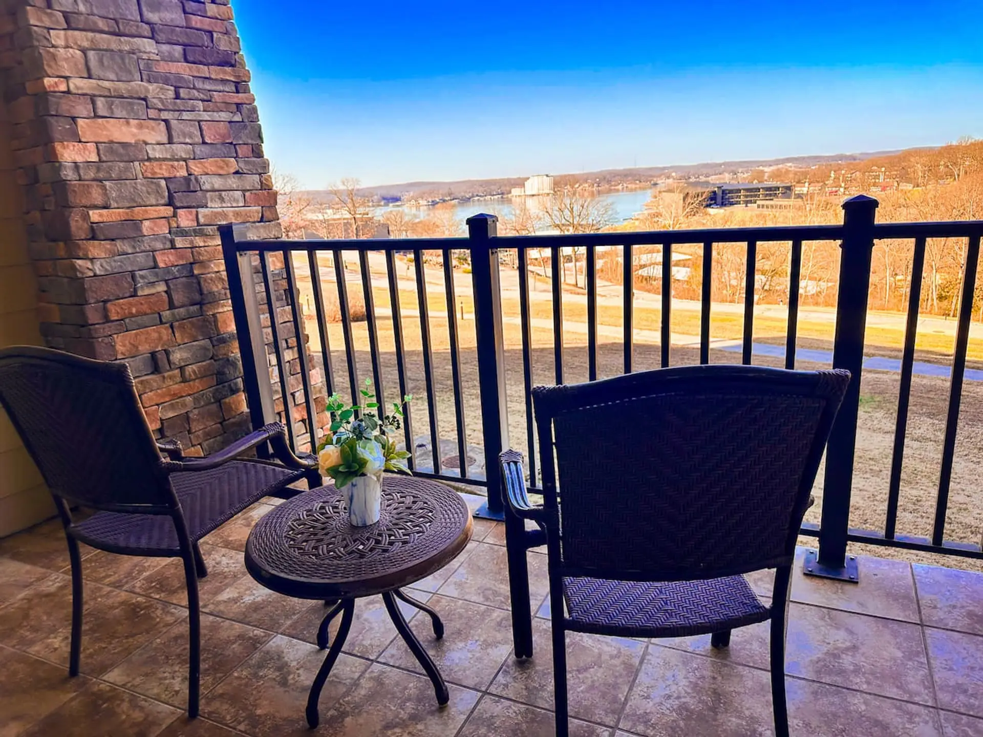 Enjoy peaceful lake views from your private balcony with comfortable seating.
