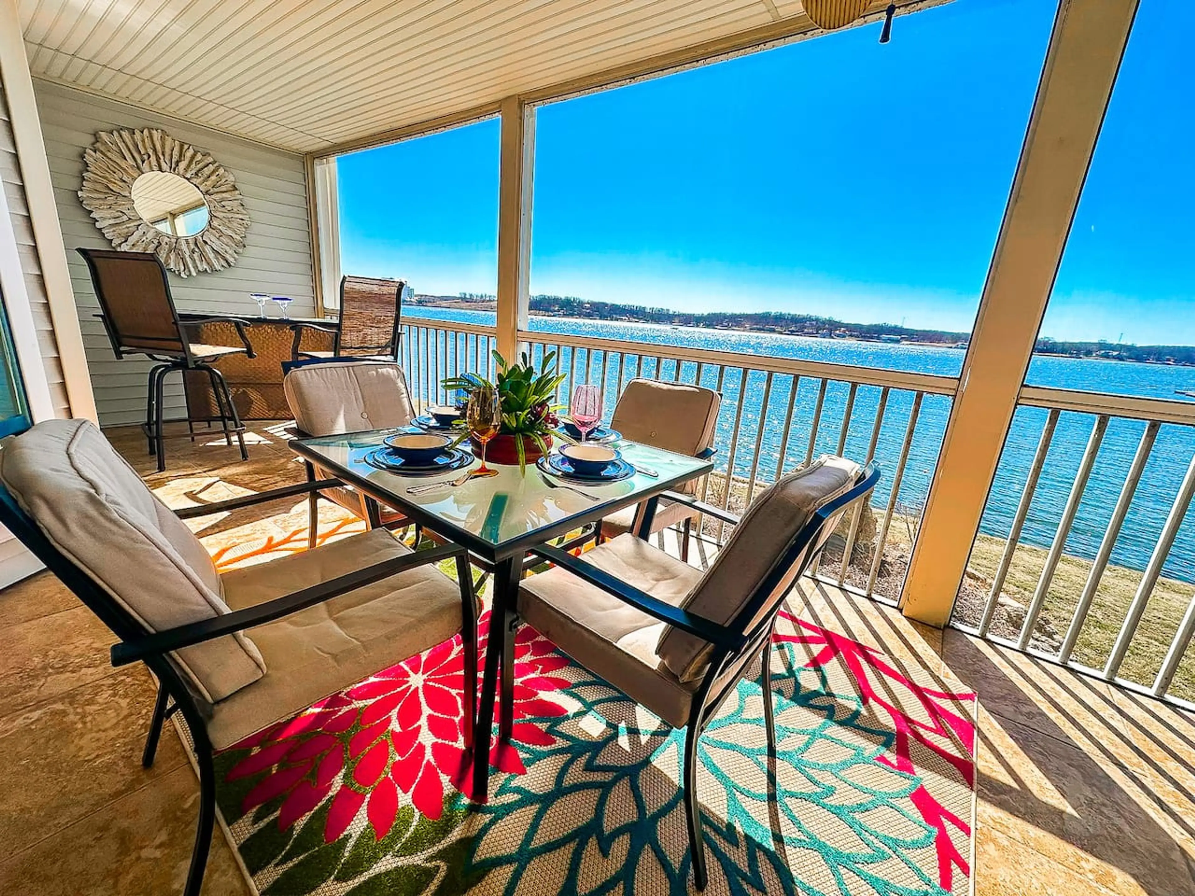 A stylish and comfortable outdoor dining space with panoramic views of the lake and marina.