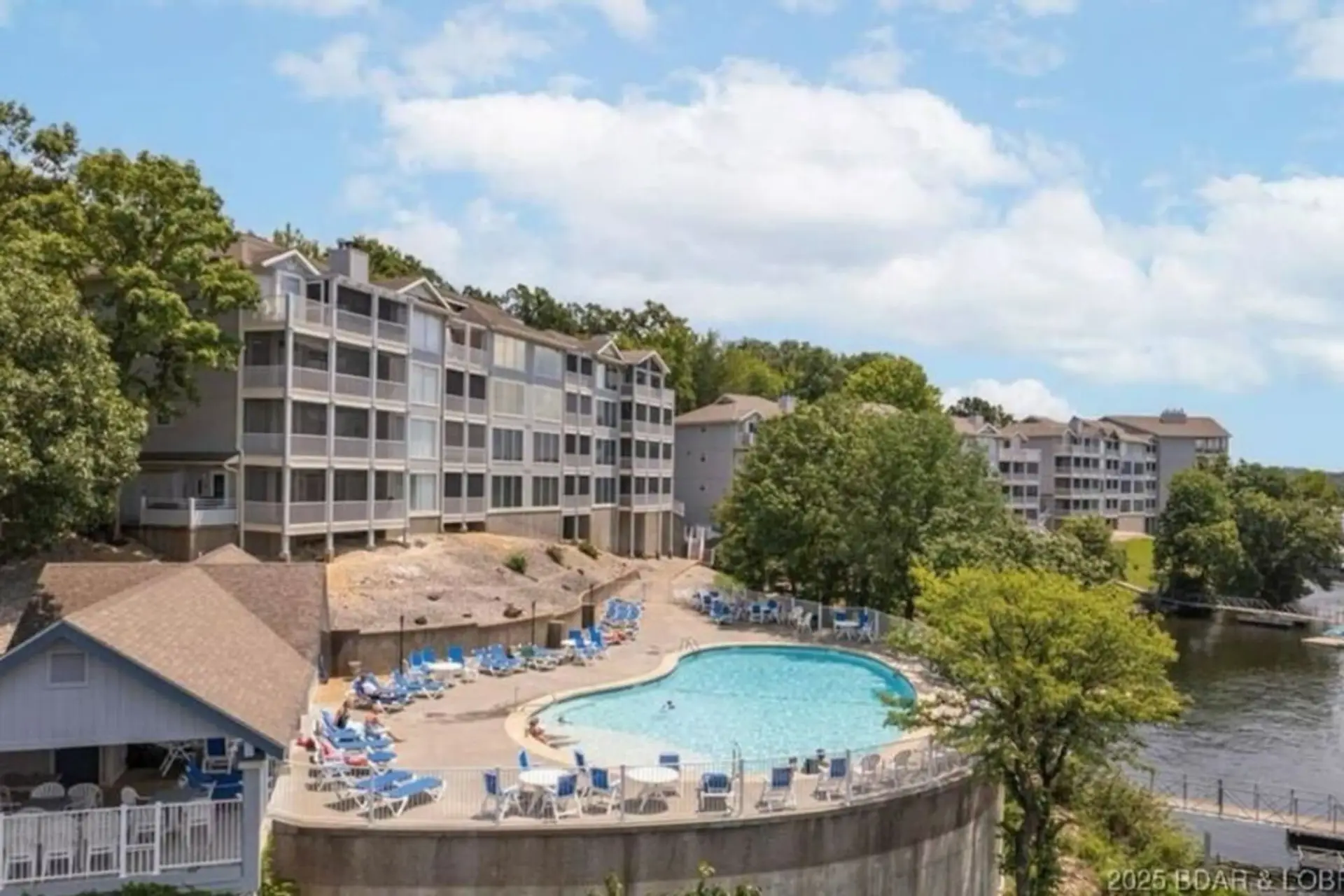 Relax in a stunning pool with panoramic lake views, perfect for unwinding in style.