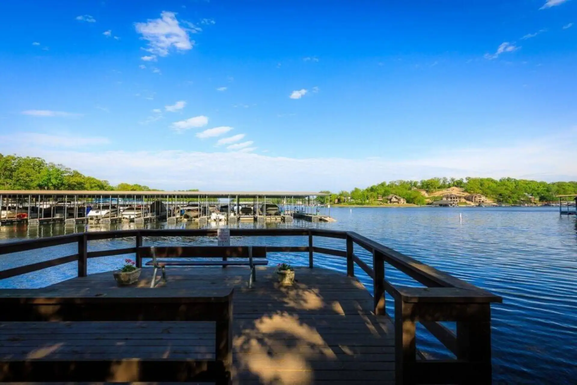 Enjoy a stunning view of the serene lake from the cozy deck, perfect for a relaxing afternoon.  This public swimdeck is part of the Knolls complex and available for guest use.