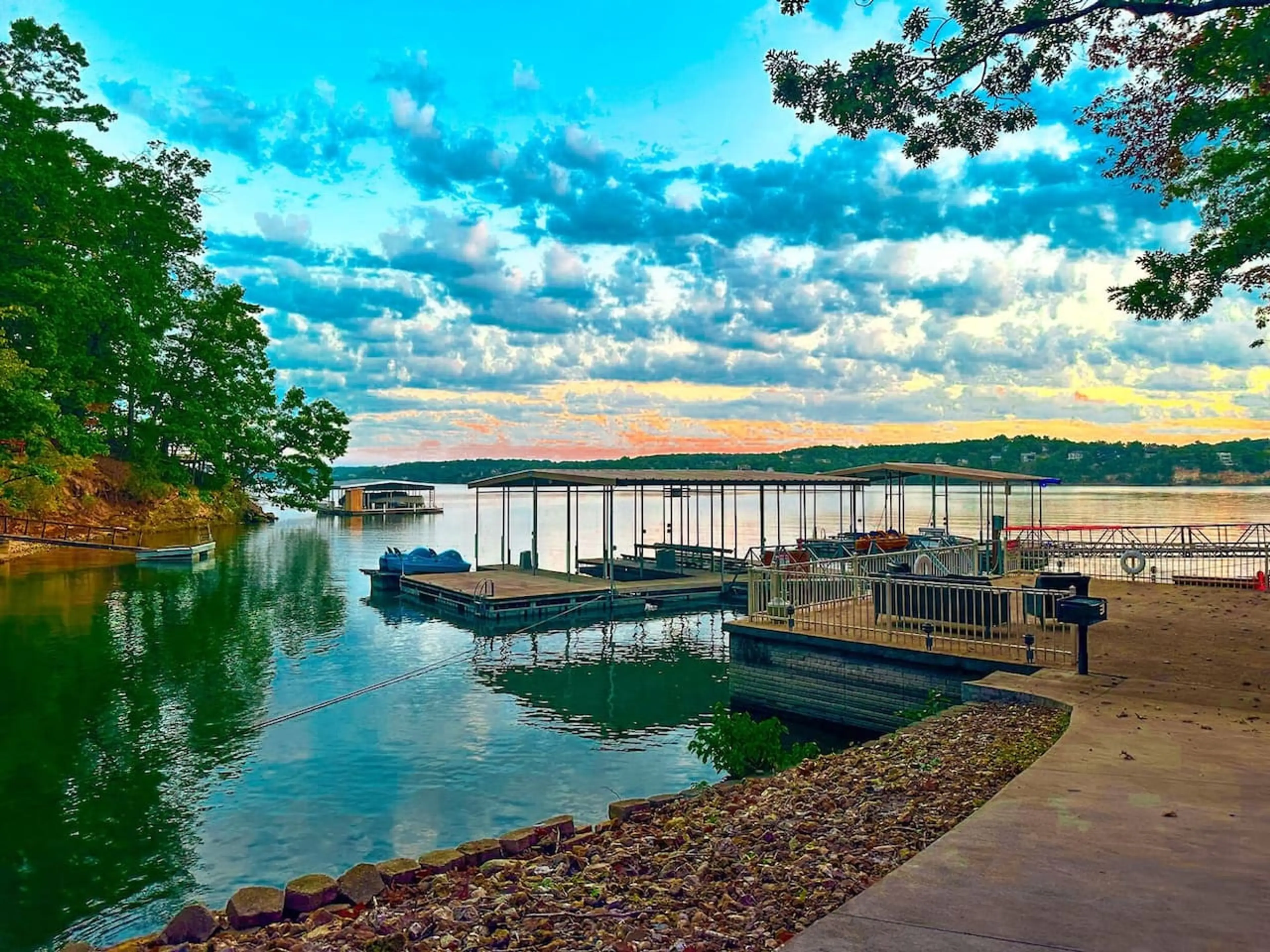 This property boasts direct access to the water with a private dock and multiple boat slips, perfect for aquatic adventures. Enjoy stunning lake views and vibrant sunsets from your lakeside retreat.