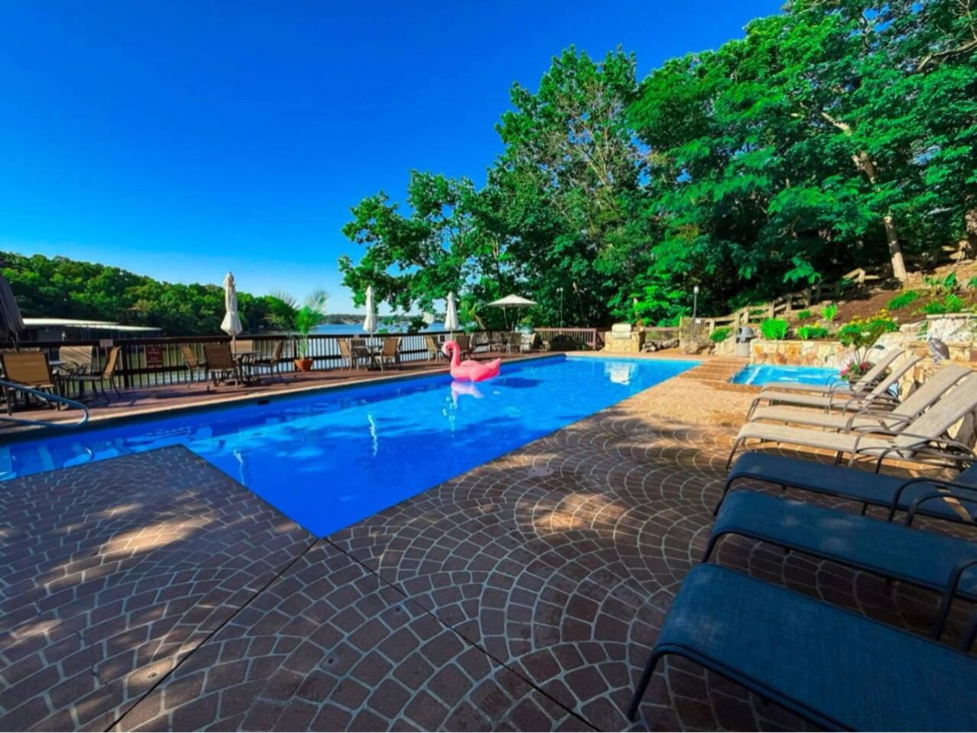 Relax by the sparkling pool at Treetop Village, complete with fun floats and a picturesque waterfall feature, creating a resort-like atmosphere.