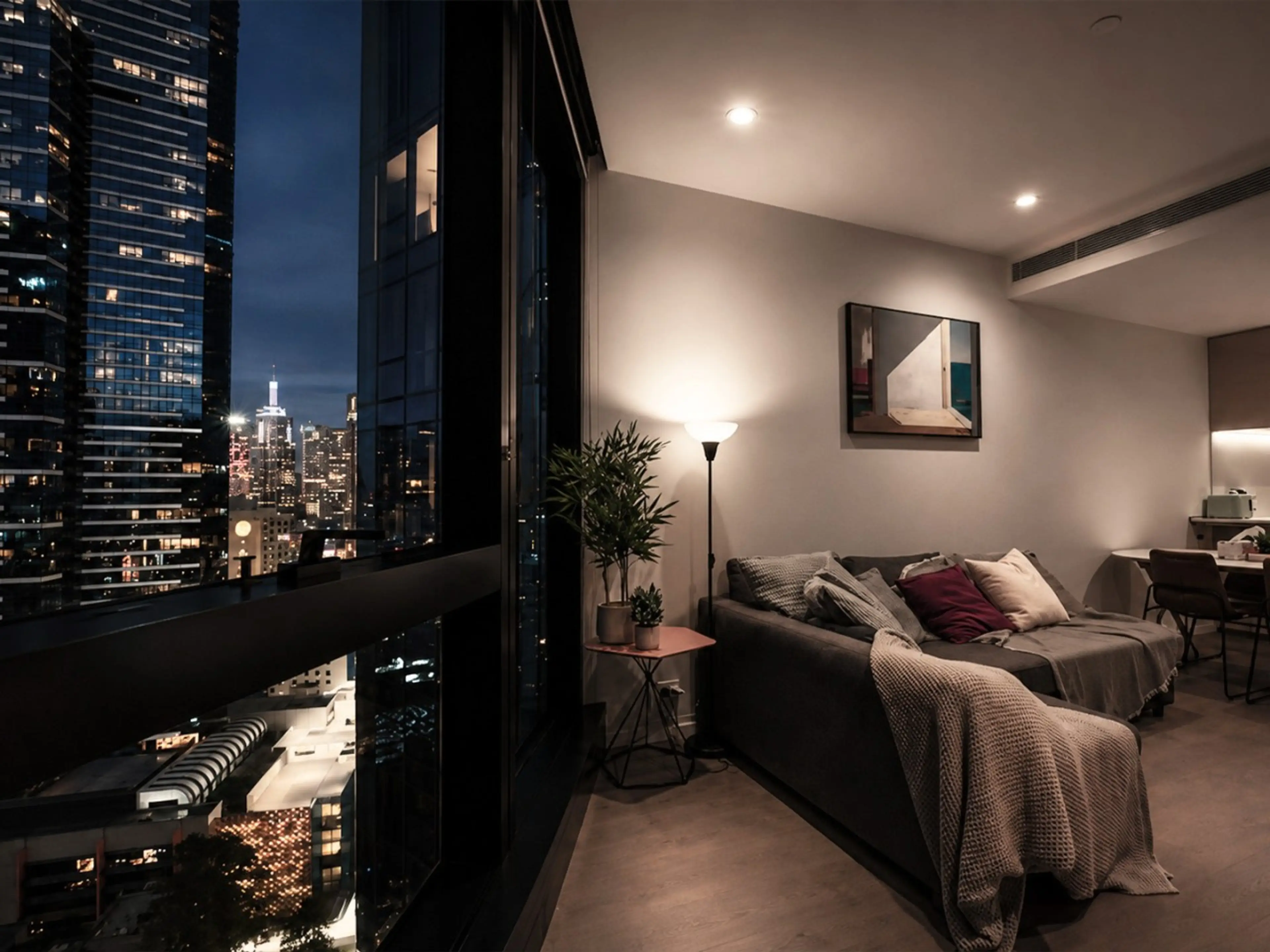 The living room is adorned with a smart HD TV, spectacular views and a sofa bed (setup available on request).