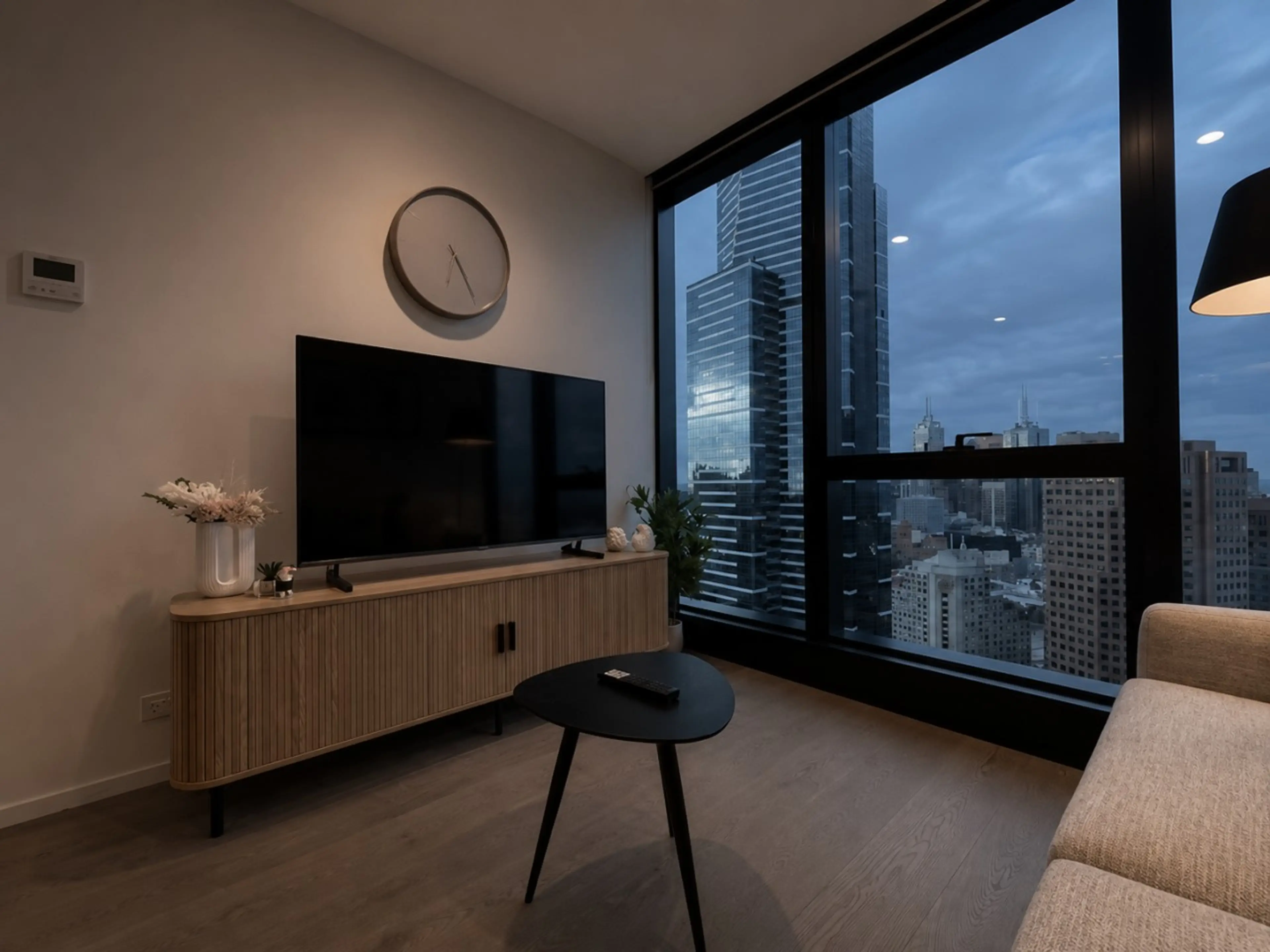 Relax on the sofa and watch TV while admiring city views.