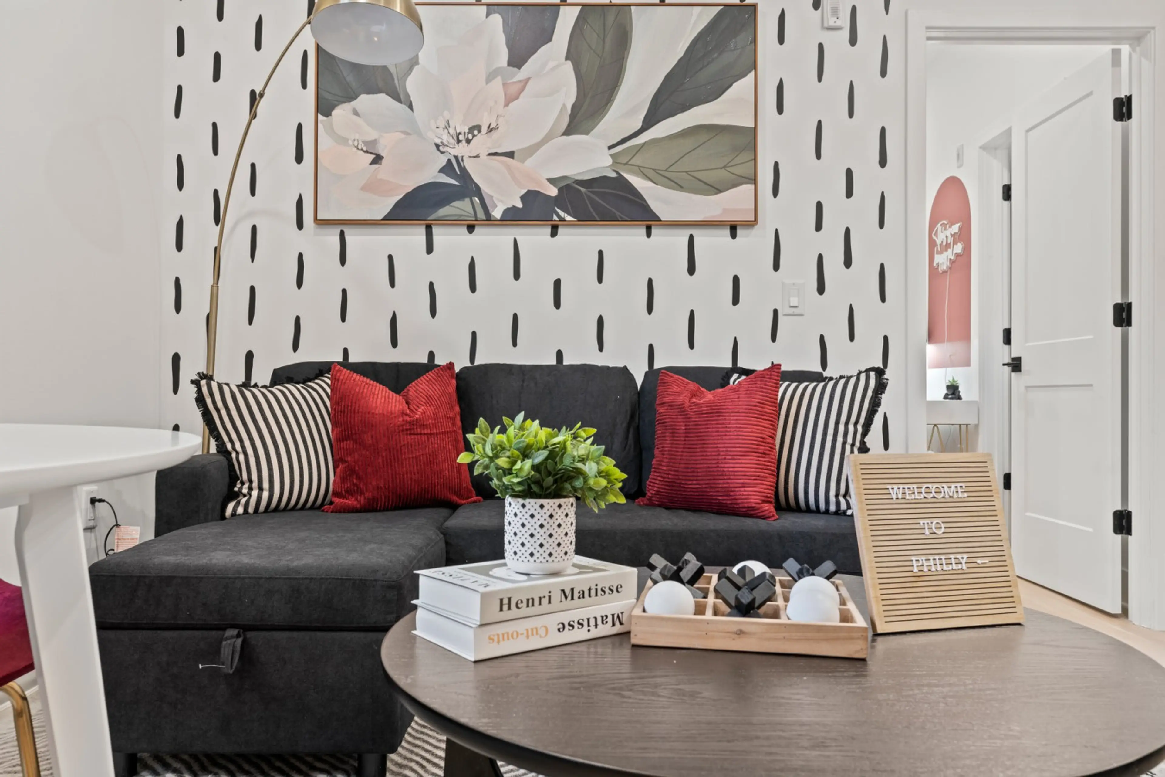 Relax on the plush charcoal sectional with chic designer accents. Perfect for a cozy movie night!